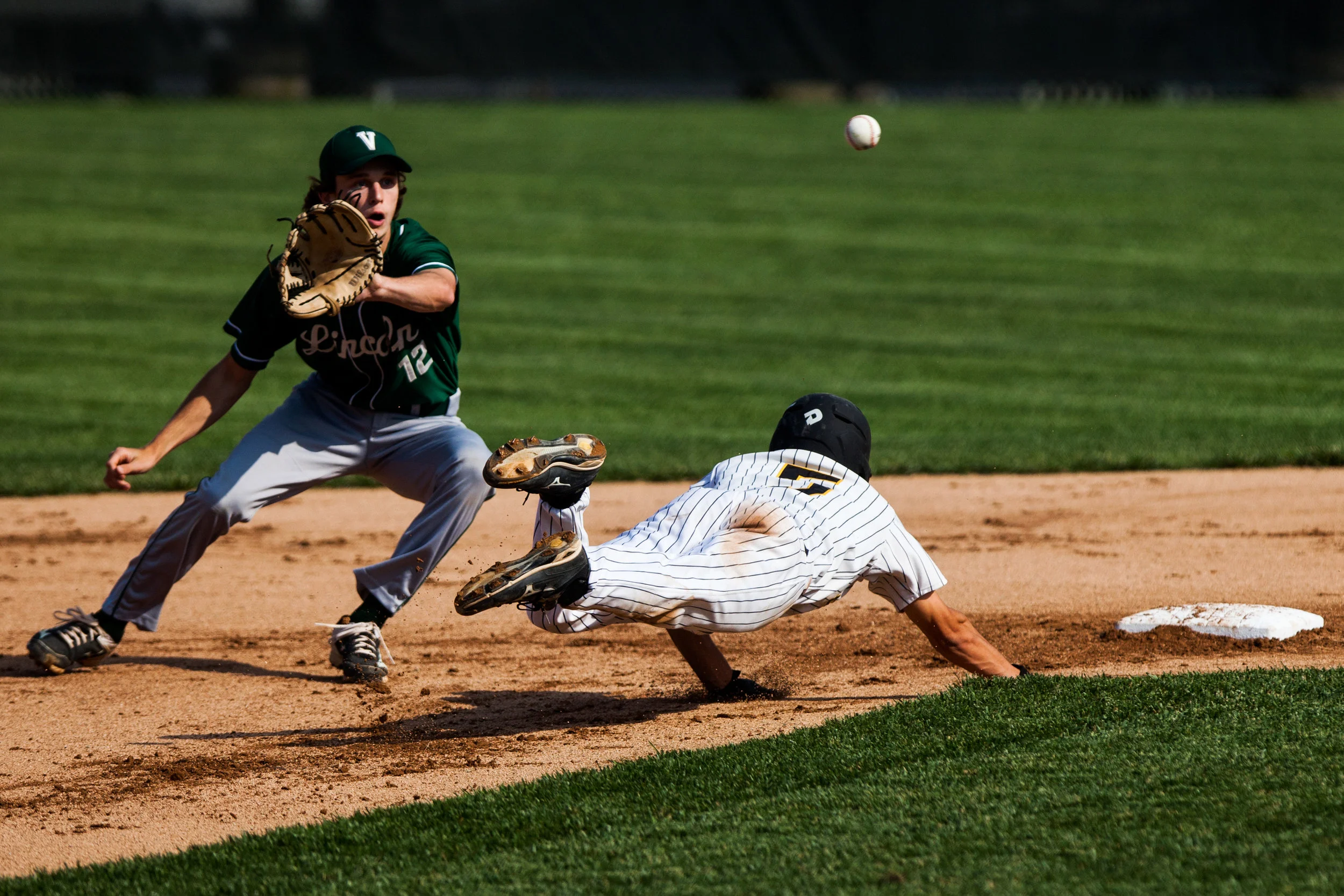 Jasper's Austin Simmers safely dove back to second after leading off the base during Thursday's Class 3A sectional at Ruxer Field in Jasper. Jasper defeated Vincennes Lincoln 8-4. 