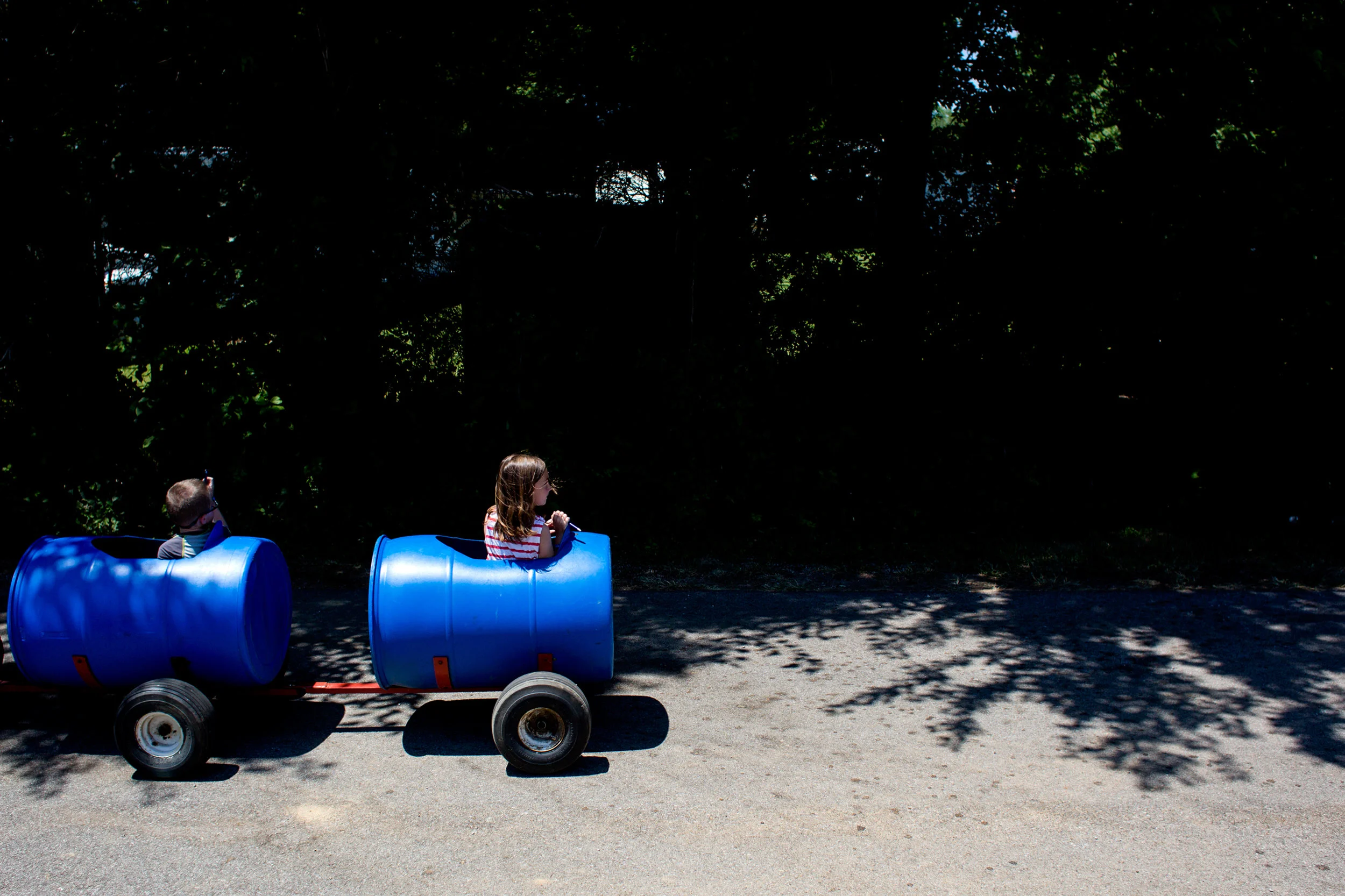 Ava Fessler of Huntingburg, 7, turned to look behind her as she rode in the caboose of the barrel ride during the town of Stendal's sesquicentennial celebration Saturday.