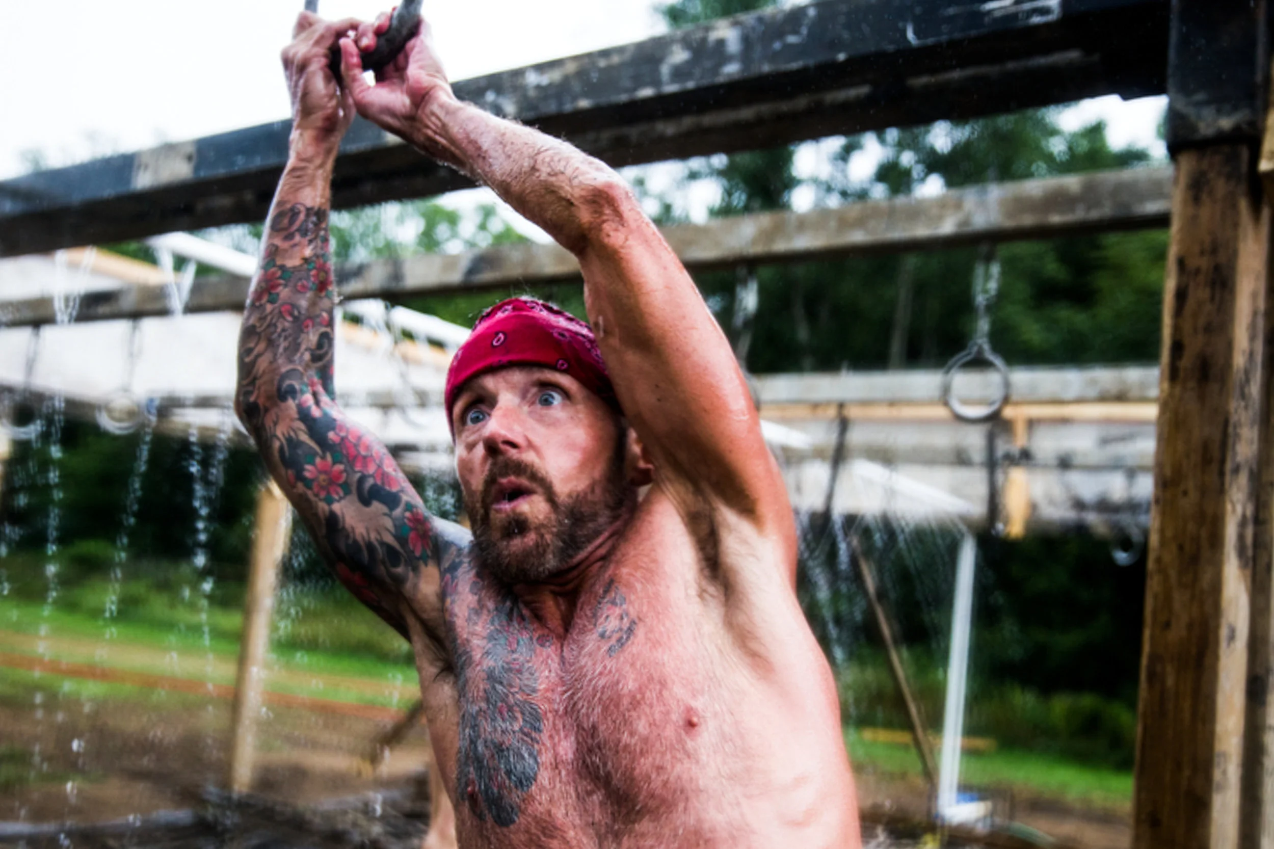 L.T. Cousineau, of Chicago, climbs an obstacle during the Warrior Dash race on Saturday, July 30, 2016 at E.A. Cummings Center in Genesee Township. The Warrior Dash course is approximately 3 miles long with 12 obstacles that requires runners to crawl through mud, scale walls, climb through cargo nets and run down dirt trails.