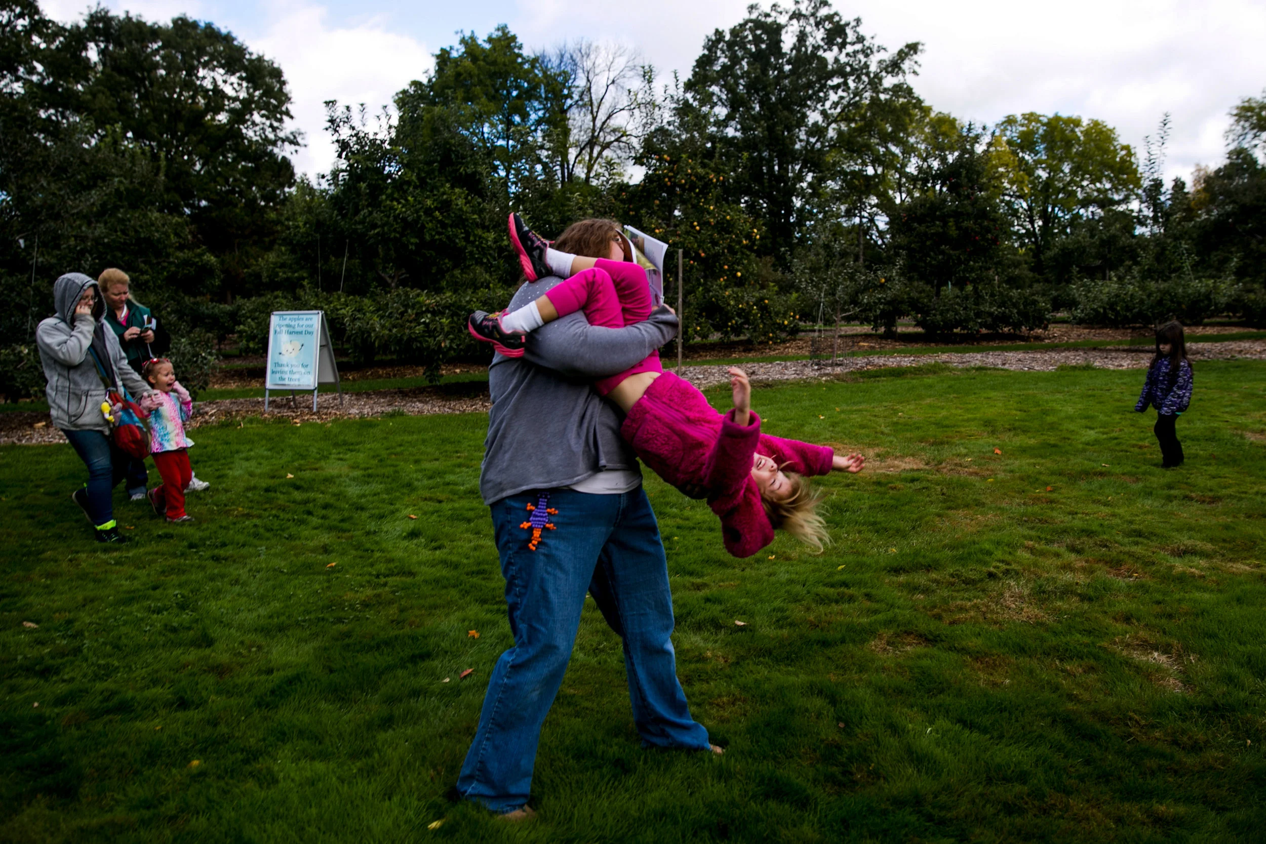 Sarah Provencher, of Davison, swings her daughter Savannah Provencher, 4, during the Apple Crunch Day at Applewood Estate in Flint.
