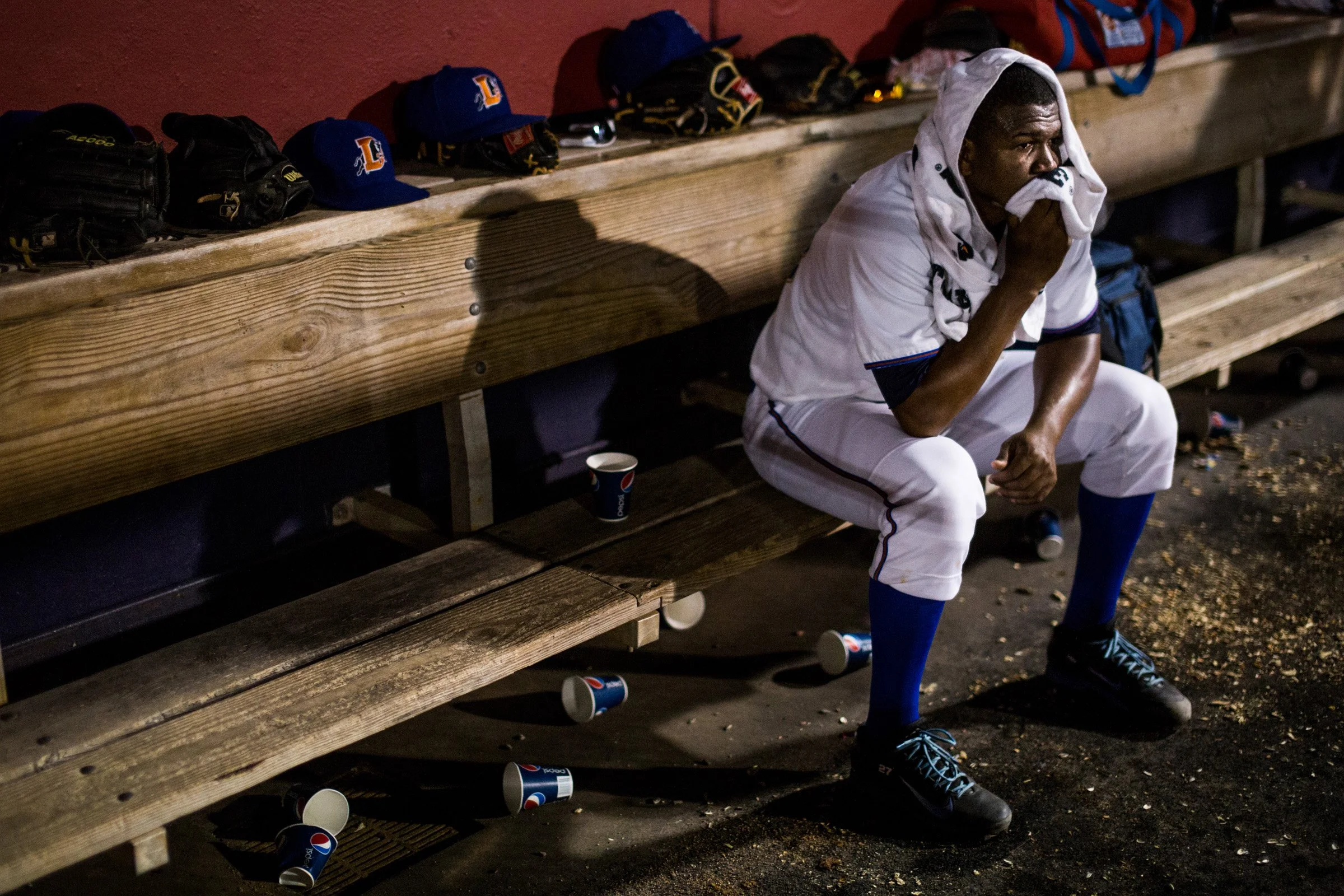 After pitching several consecutive walks, Enny Romero takes a break in the dugout during a game against the Norfolk Tides at the Durham Bulls Athletic Park.