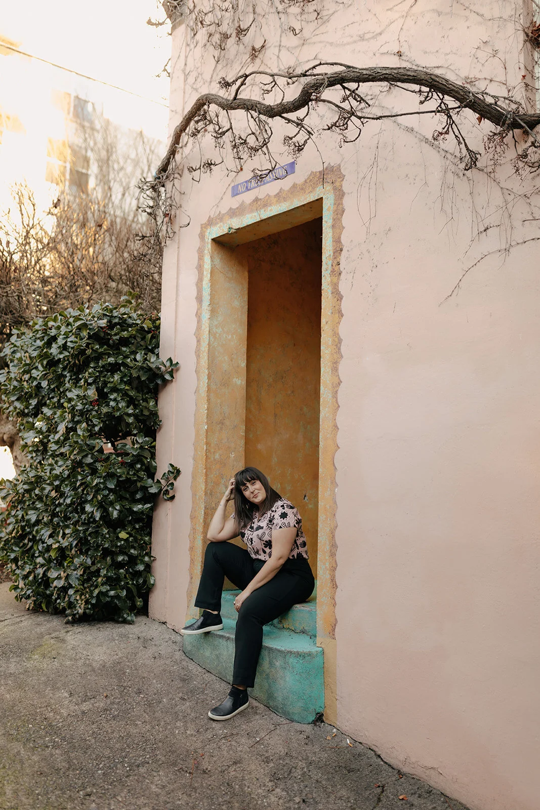 Karen Kirsch sitting on a stair smiling