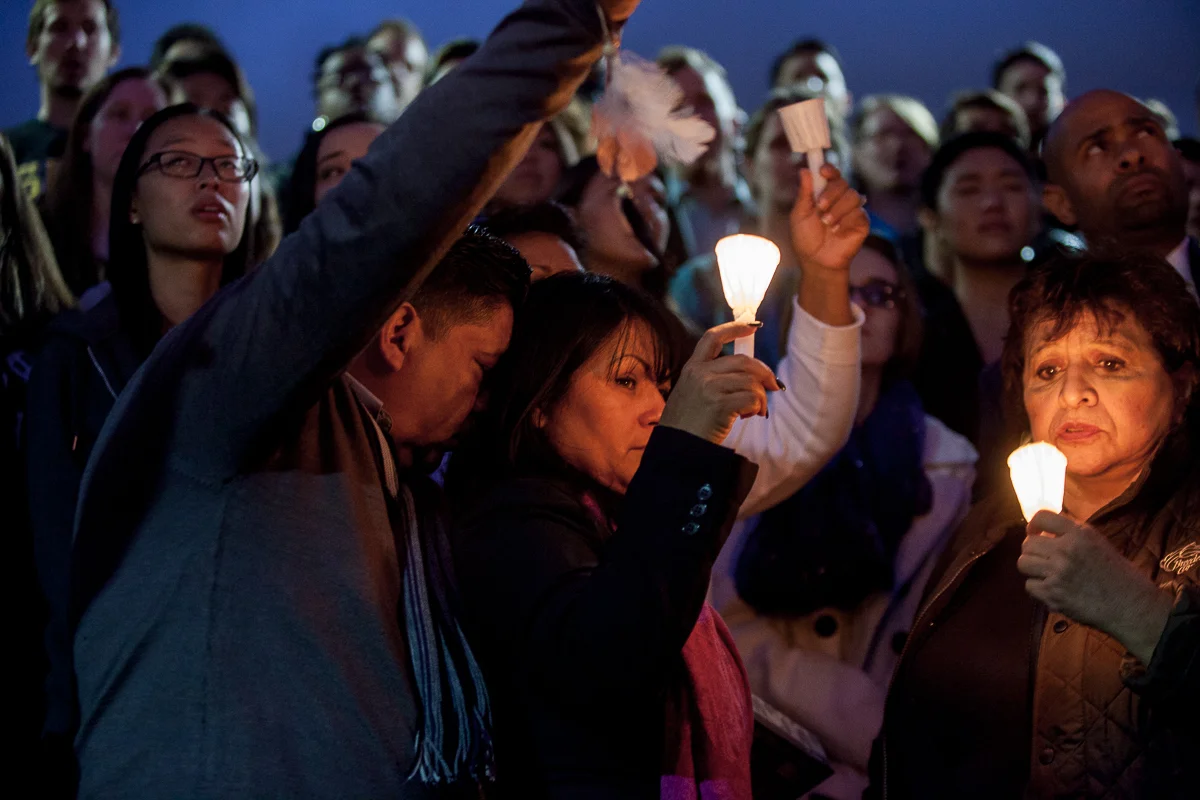 Nohemi's mother is seen here being comforted by her husband, Nohemi's step-father. All guests were asked to raise their candles to the heavens as the CSULB Choir sung a hymn. 