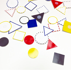 prototype 02a: playing pieces users were given a bag of playing pieces, a velcro board, and a call to action. users were then asked to combine shapes — differentiated by color, line, and form — to visualize expressions like look! emergency! help!