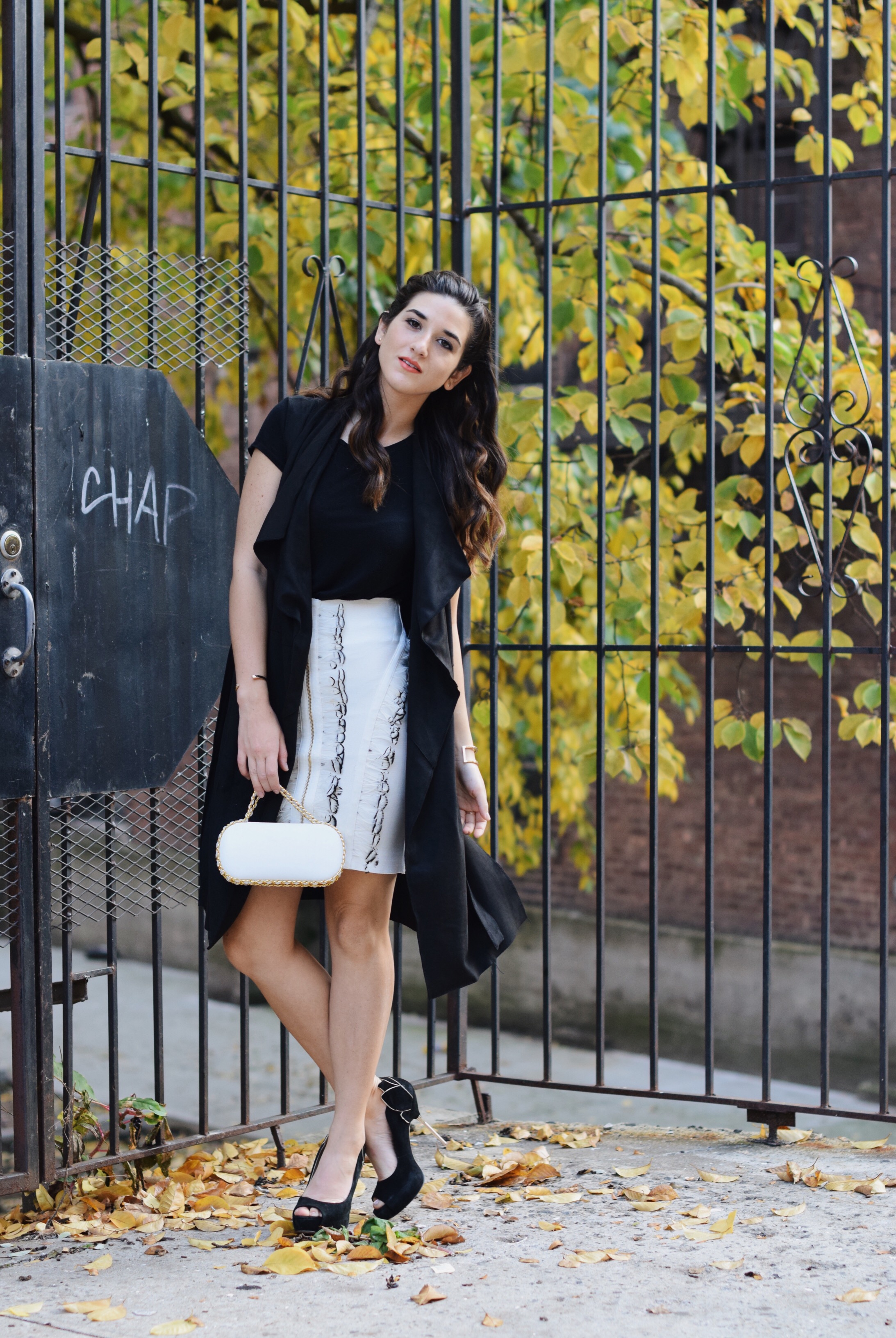 White Feather Skirt Long Black Vest Wow Couture Louboutins & Love Fashion Blog Esther Santer NYC Street Style Blogger Photoshoot Hairstyle Inspo Heels Gold Black Tee Zara Outfit OOTD Beauty Braid Winter Fall Girl Women Model Erin Dana White Minaudiere.JPG