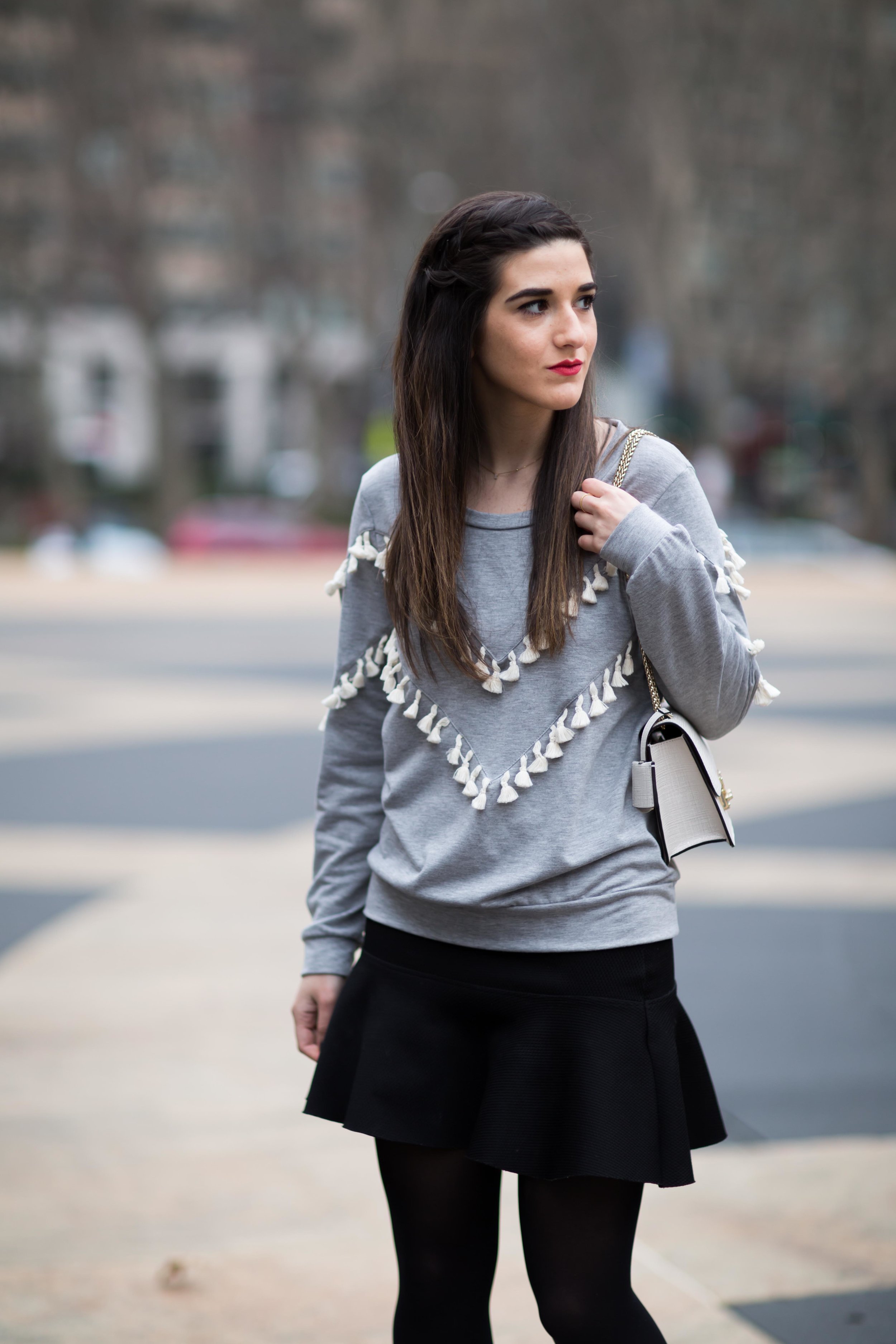 Grey Tassel Sweatshirt Everything You Wanted To Know About Blog Interns Esther Santer Fashion Blog NYC Street Style Blogger Outfit OOTD Trendy Henri Bendel Waldorf Party Bag Black Mini Skirt Booties Shoes Cozy Tights Photoshoot Model  Girl Women Hair.jpg