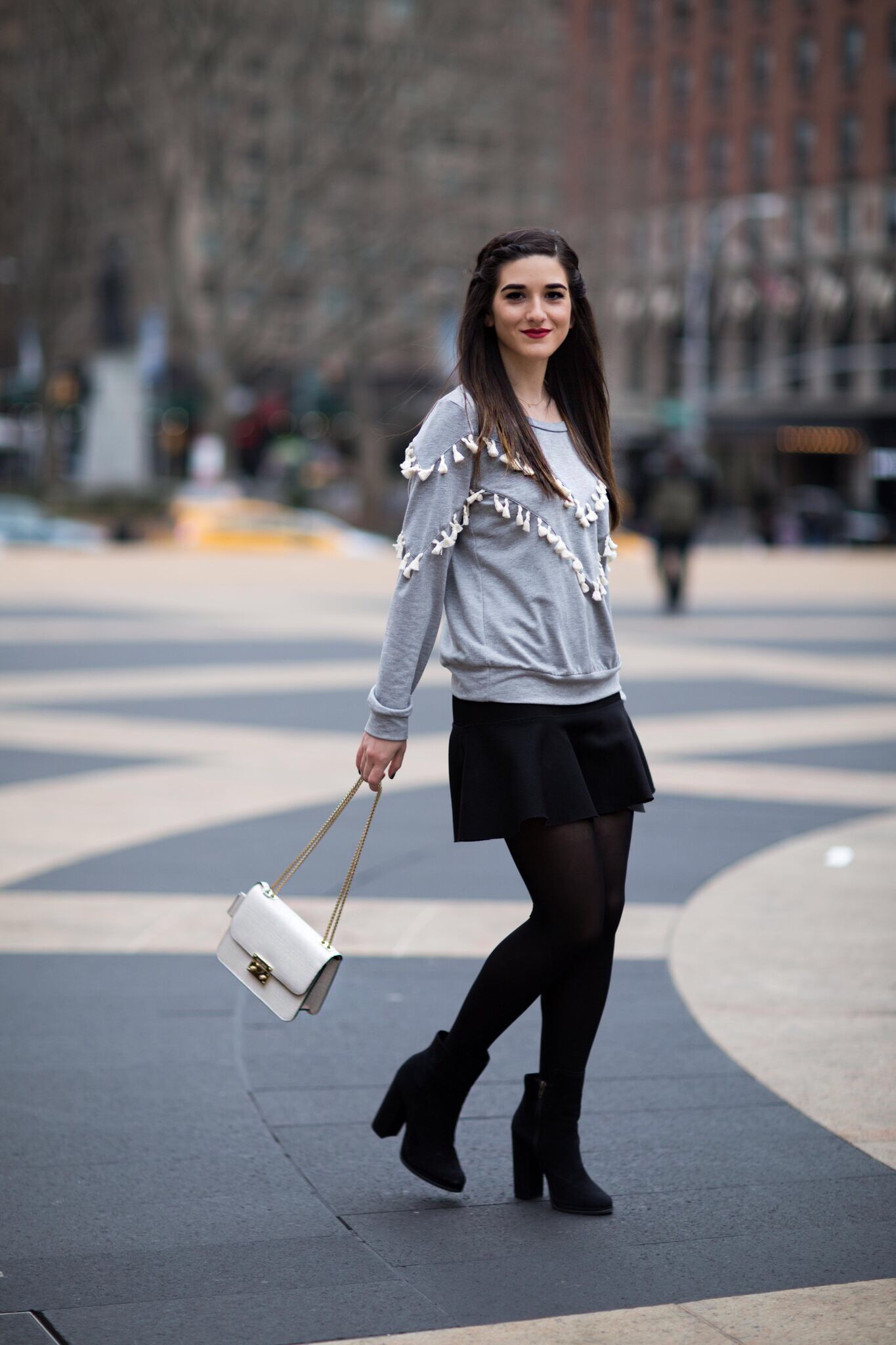 Grey Tassel Sweatshirt Everything You Wanted To Know About Blog Interns Esther Santer Fashion Blog NYC Street Style Blogger Outfit OOTD Trendy Henri Bendel Waldorf Party Bag Black Mini Skirt Booties Shoes  Cozy Tights Photoshoot Model Girl Women Hair.jpg
