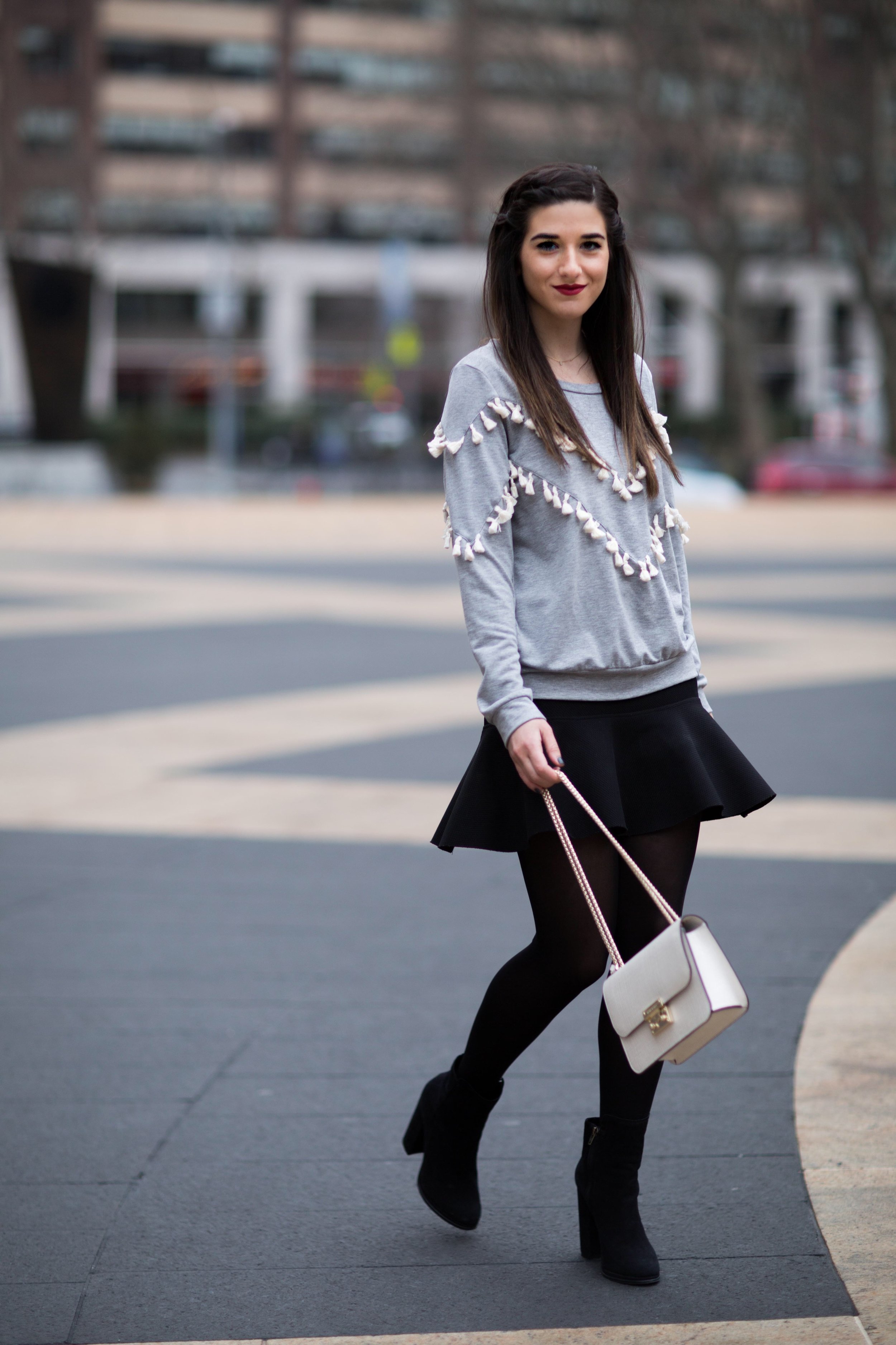 Grey Tassel Sweatshirt Everything You Wanted To Know About Blog Interns Esther Santer Fashion Blog NYC Street Style Blogger Outfit OOTD Trendy Henri Bendel Waldorf Party Bag Black Mini Skirt Booties Shoes Cozy Tights Photoshoot Model Girl Women  Hair.jpg