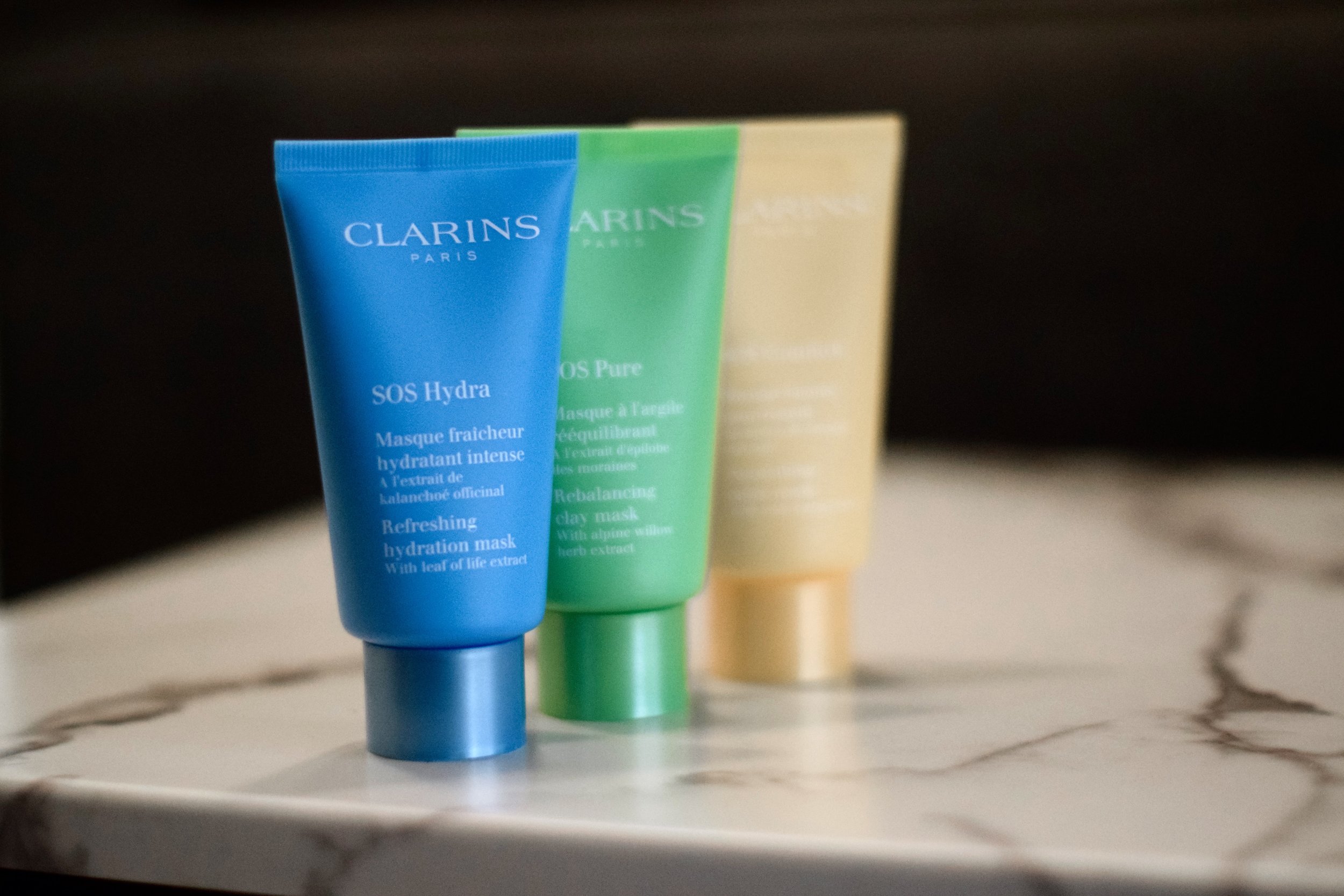 SOS Face Masks Clarins Esther Santer Fashion Blog NYC Street Style Blogger Outfit OOTD Trendy Beauty Product Review Colorful Blue Green Yellow Bottle Moisturize Masque Rebalancing Shop Skincare Skin Routine Comfort Girl Women New York City Hydrate.jpg