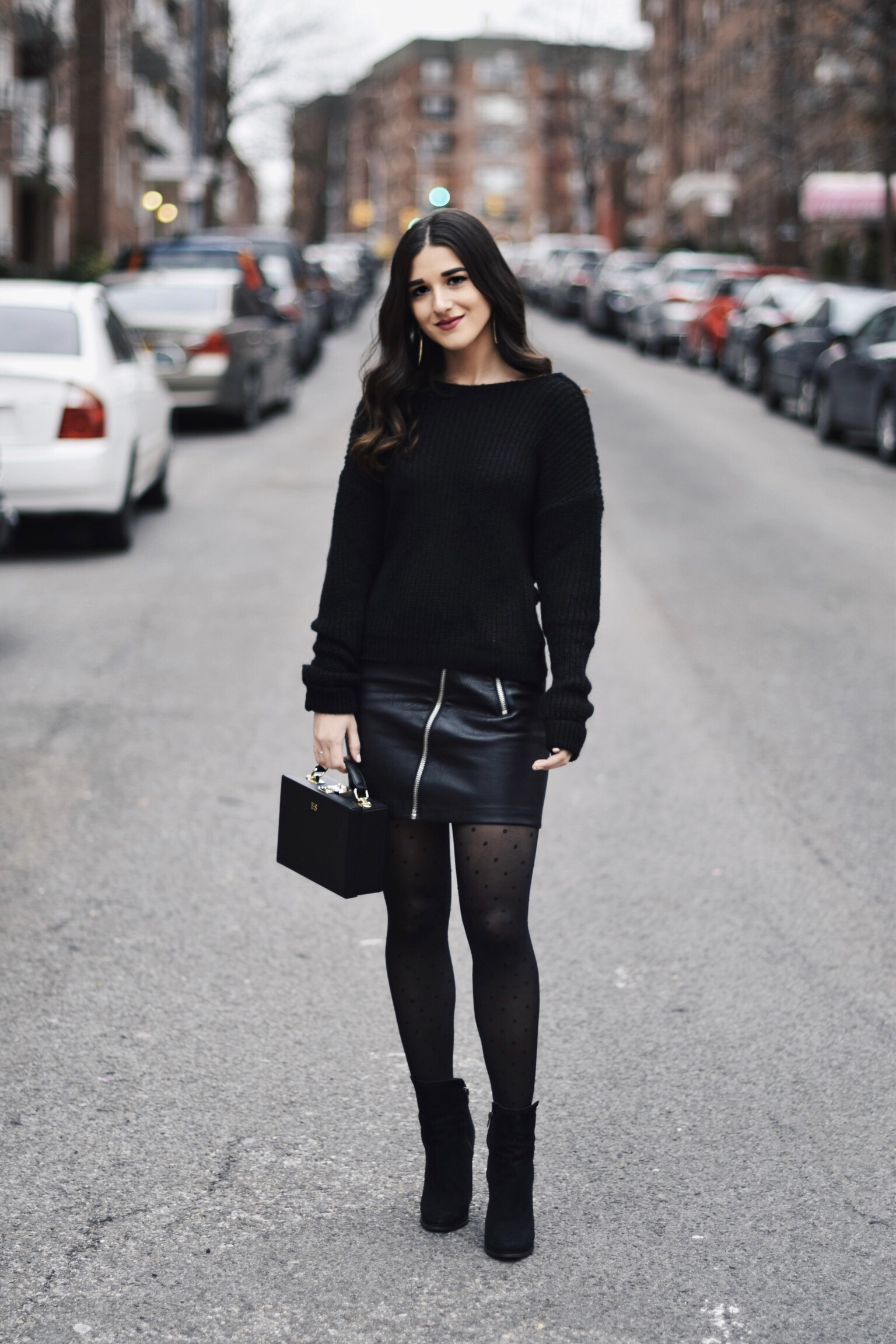 All Black Look 5 Ways To Keep Your New Year's Resolution Going Strong Esther Santer Fashion Blog NYC Street Style Blogger Outfit OOTD Trendy BaubleBar Earrings Monogrammed Box Bag Daily Edited Girl  Women Booties Pleather Mini Skirt Polka Dot Tights.jpg