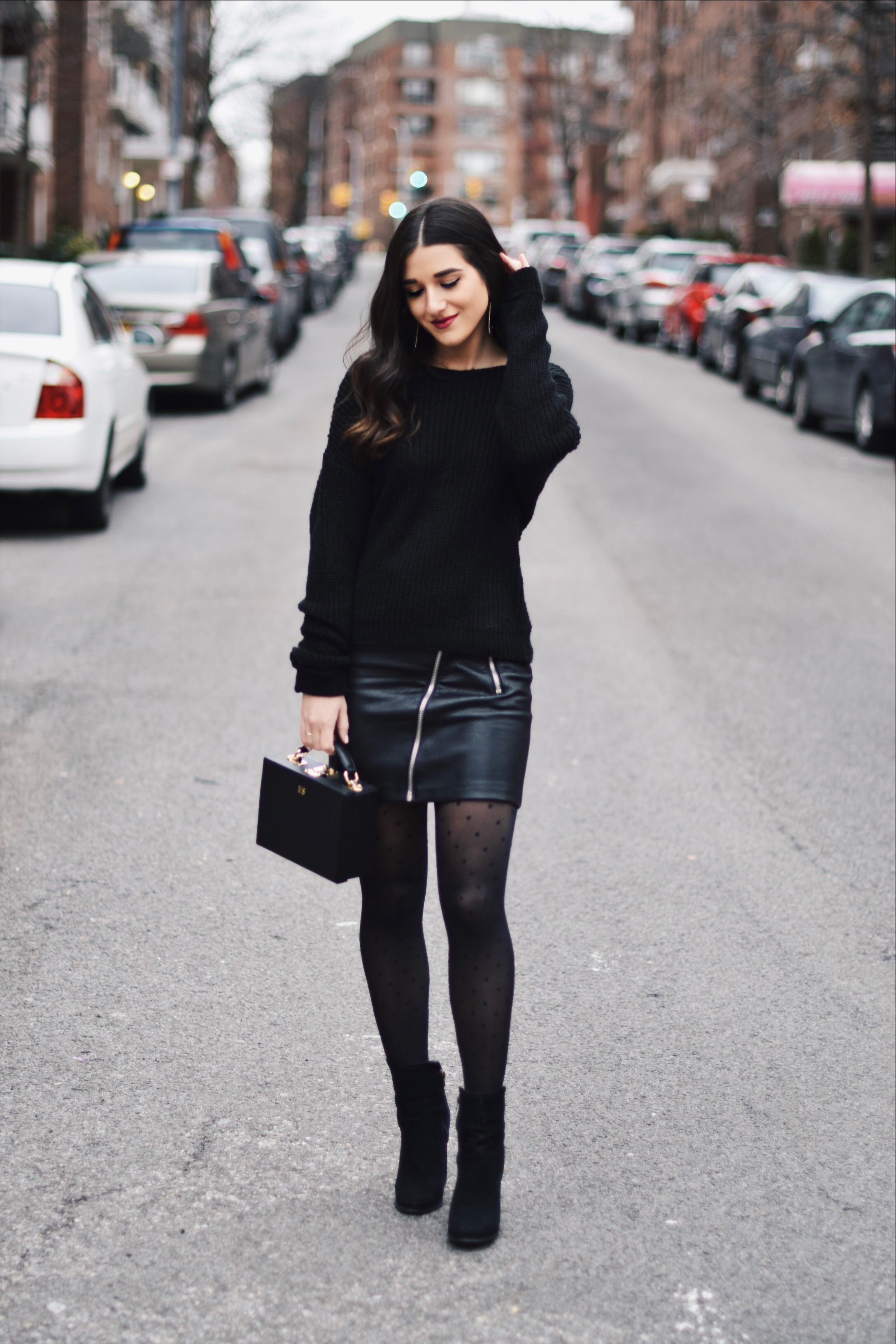 All Black Look 5 Ways To Keep Your New Year's Resolution Going Strong Esther Santer Fashion Blog NYC Street Style Blogger Outfit OOTD Trendy BaubleBar Earrings Monogrammed Box Bag Daily Edited Girl Women Booties Pleather Mini Skirt Polka Dot  Tights.jpg