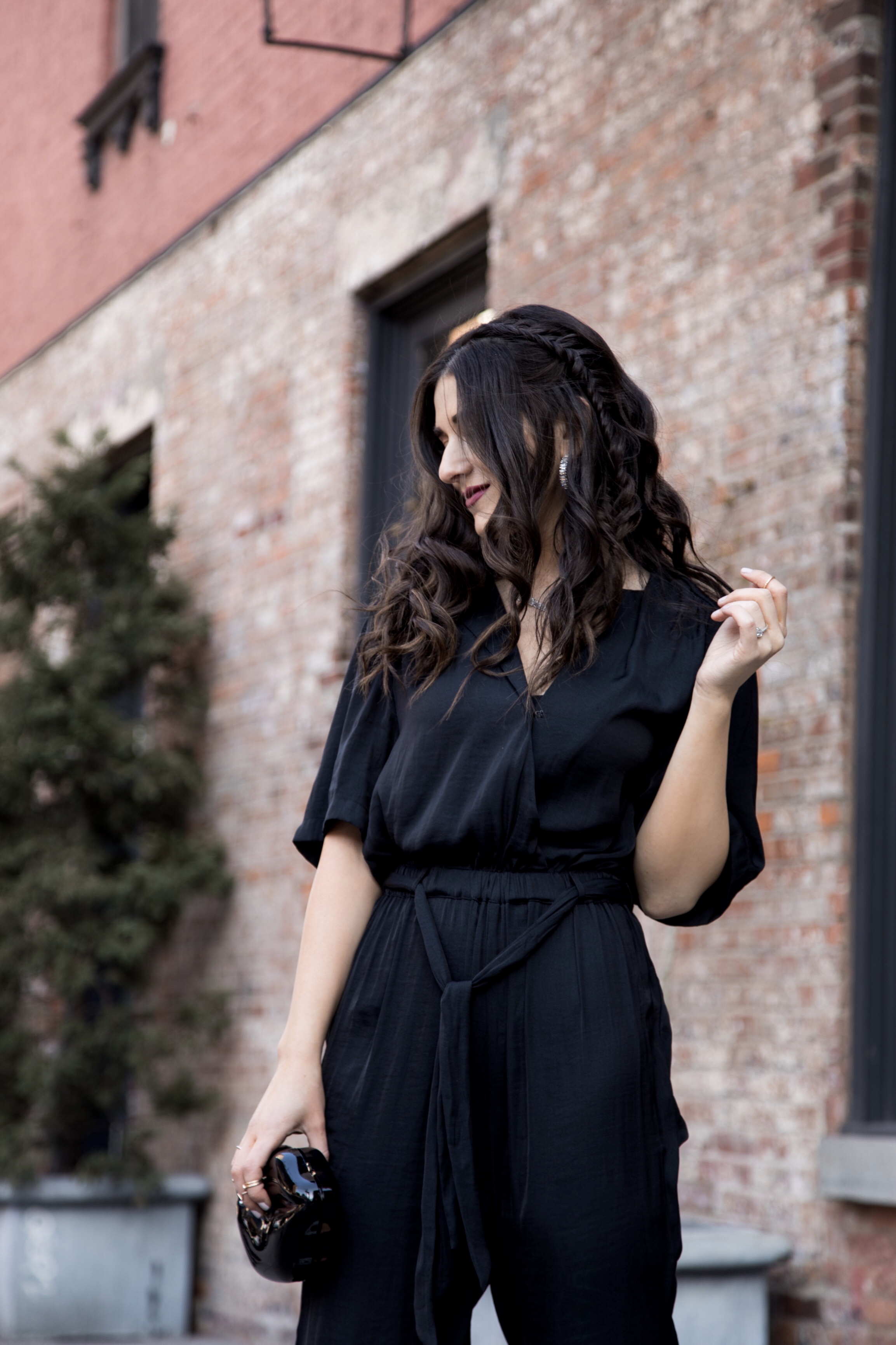 Where We're Going For Our Honeymoon Black Silk Jumpsuit Bow Mules Esther Santer Fashion Blog NYC Street Style Blogger Outfit OOTD Trendy Urban Outfitters Betsey Johnson Brand Collab Jeweled Shoes Earrings Hoops Melissa Lovy Necklace Lips Clutch Braid.jpg