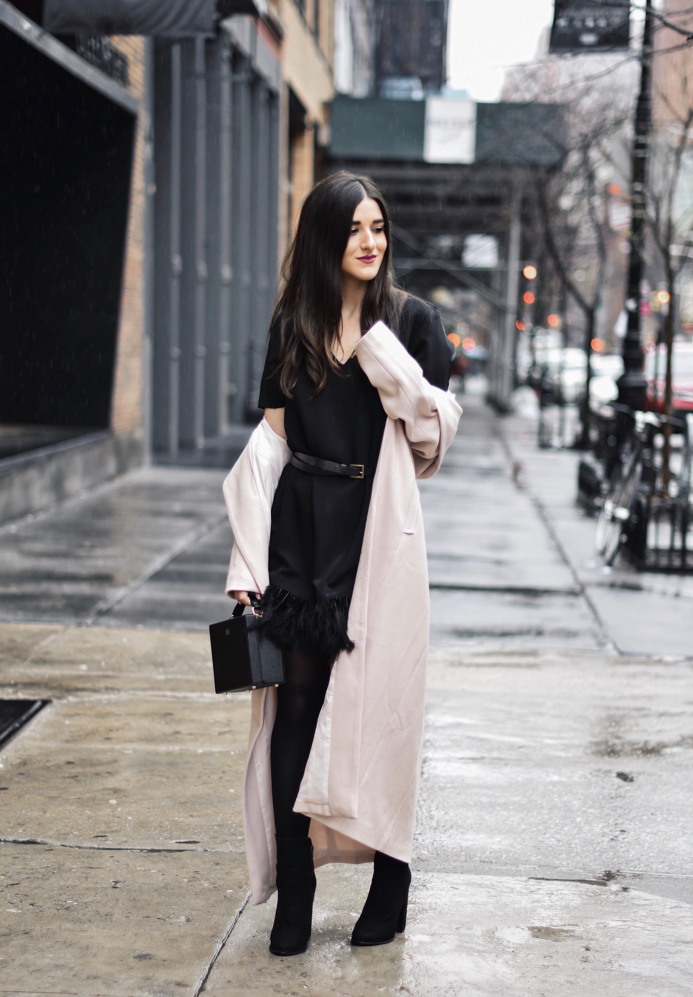 How To Stay Grounded Black Feather Trim Dress Long Pink Coat Esther Santer Fashion Blog NYC Street Style Blogger Outfit OOTD Trendy Saks Off 5th Feather Trim Dress Black Tights Booties M4D3 Shoes ASOS Belt Blush Box Clutch Bag Shop Wear Cozy  Winter.jpg