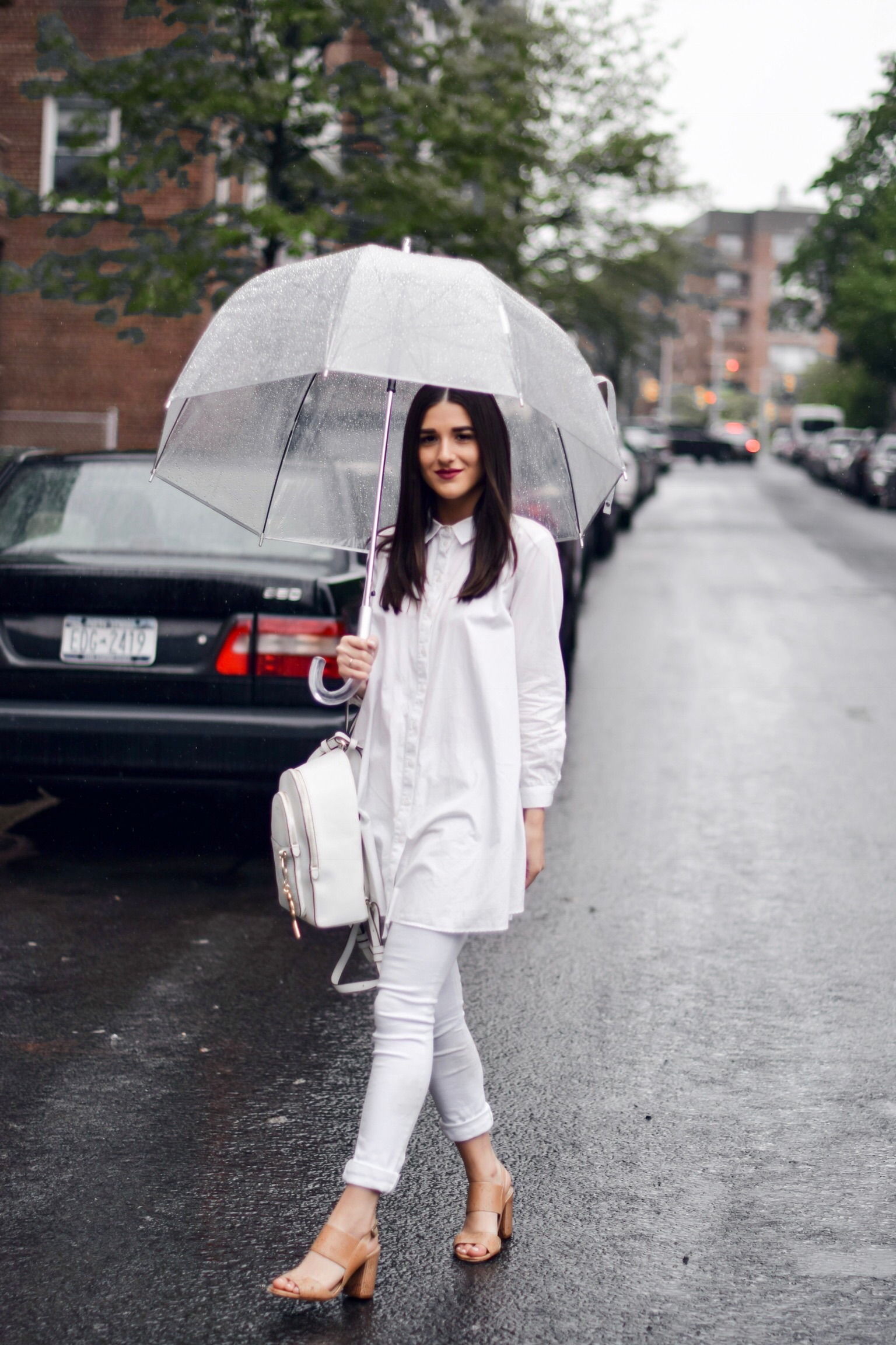 Why I Won't Be Bringing My Camera Or Laptop To Portugal Or Spain All White Look Esther Santer Fashion Blog NYC Street Style Blogger Outfit OOTD Trendy Shopping Umbrella Rainy Day Button Down Sandals Heels Zara Pants Straight Hair Girl Women New York.jpg