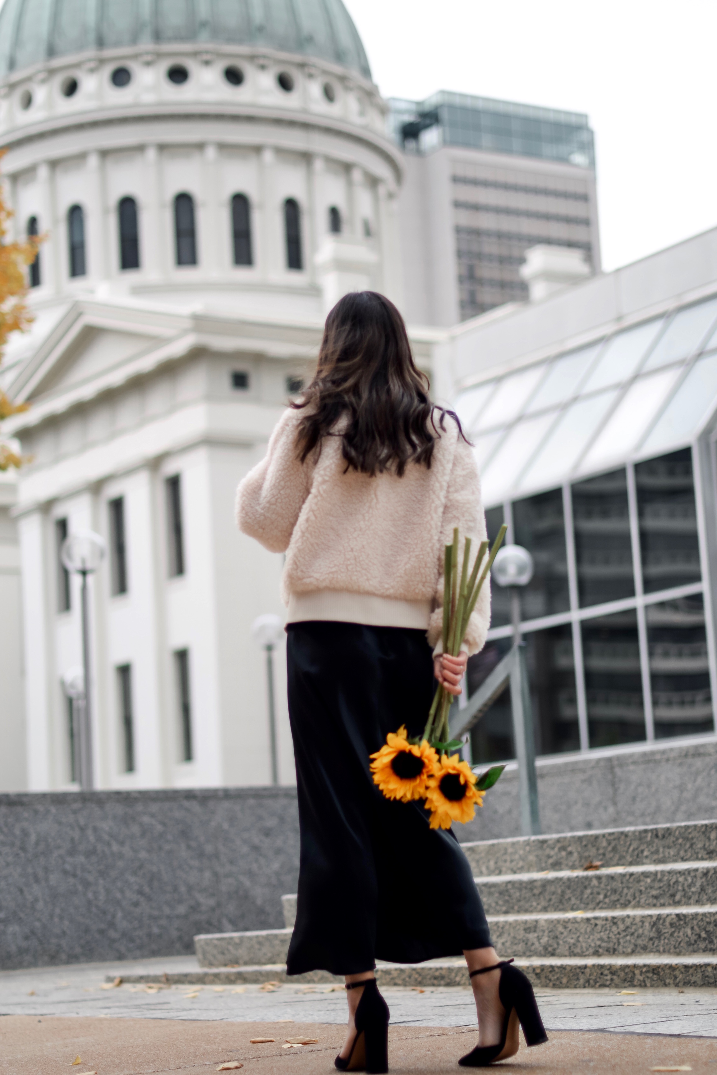 The 10 Most Frustrating Parts Of Brand Collabs Long Black Slip Dress Shearling Jacket Esther Santer Fashion Blog NYC Street Style Blogger Outfit OOTD Trendy Shopping St. Louis Photoshoot Hometown Downtown Saint Louis Sunflowers Yellow Flowers Heels.jpg
