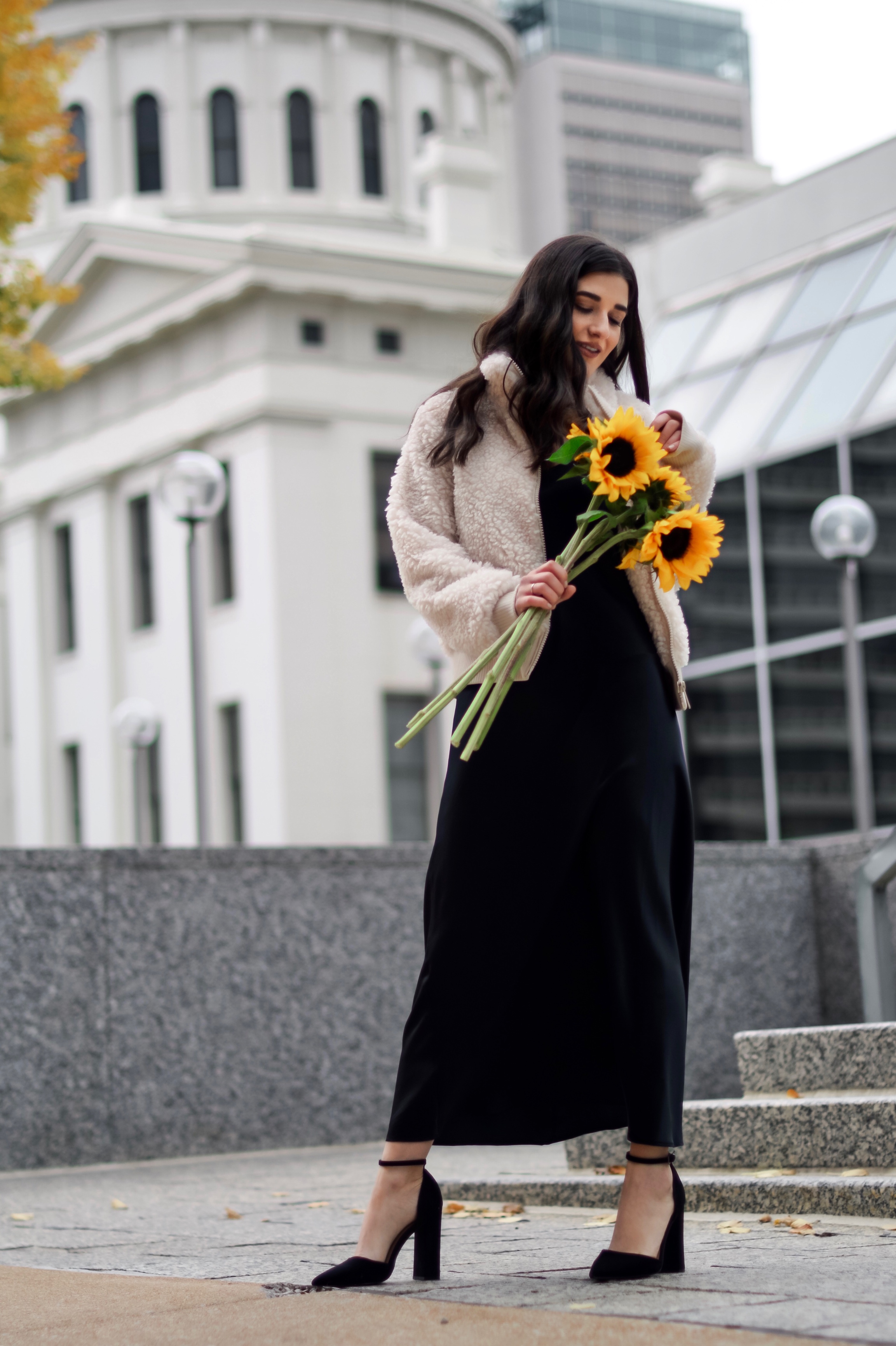 The 10 Most Frustrating Parts Of Brand Collabs Long Black Slip Dress Shearling Jacket Esther Santer Fashion Blog NYC Street Style Blogger Outfit OOTD Trendy Shopping St. Louis Photoshoot Hometown Downtown Saint Louis  Sunflowers Yellow Flowers Heels.jpg