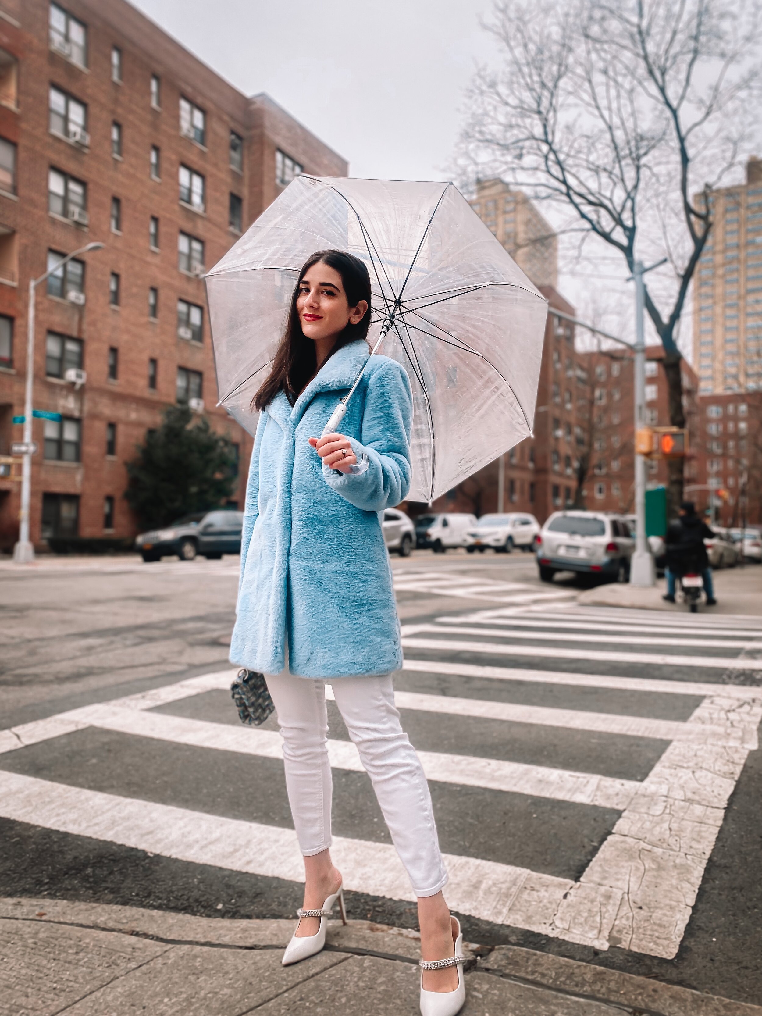 Esther Santer NYC Street Style Fashion Blogger New York City What To Wear Casual Shop Buy Girl Women Baby Blue Faux Fur Coat Calvin Klein Target Clear Dome Umbrella White Jeans 7 For All Mankind Kurt Geiger Duke White  Jewel Heels Tripod Photo Rainy.JPG