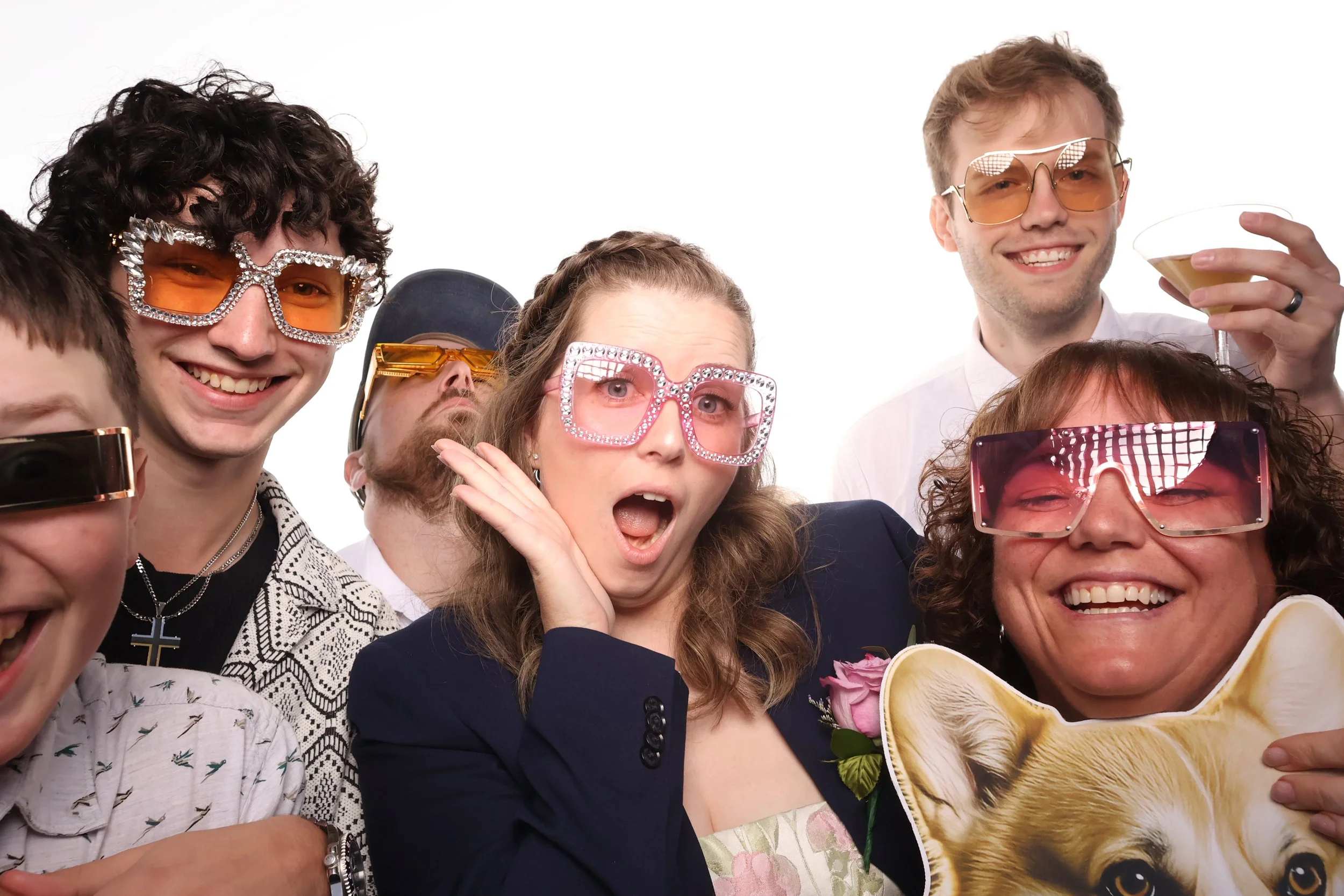 A happy wedding group working the photo booth