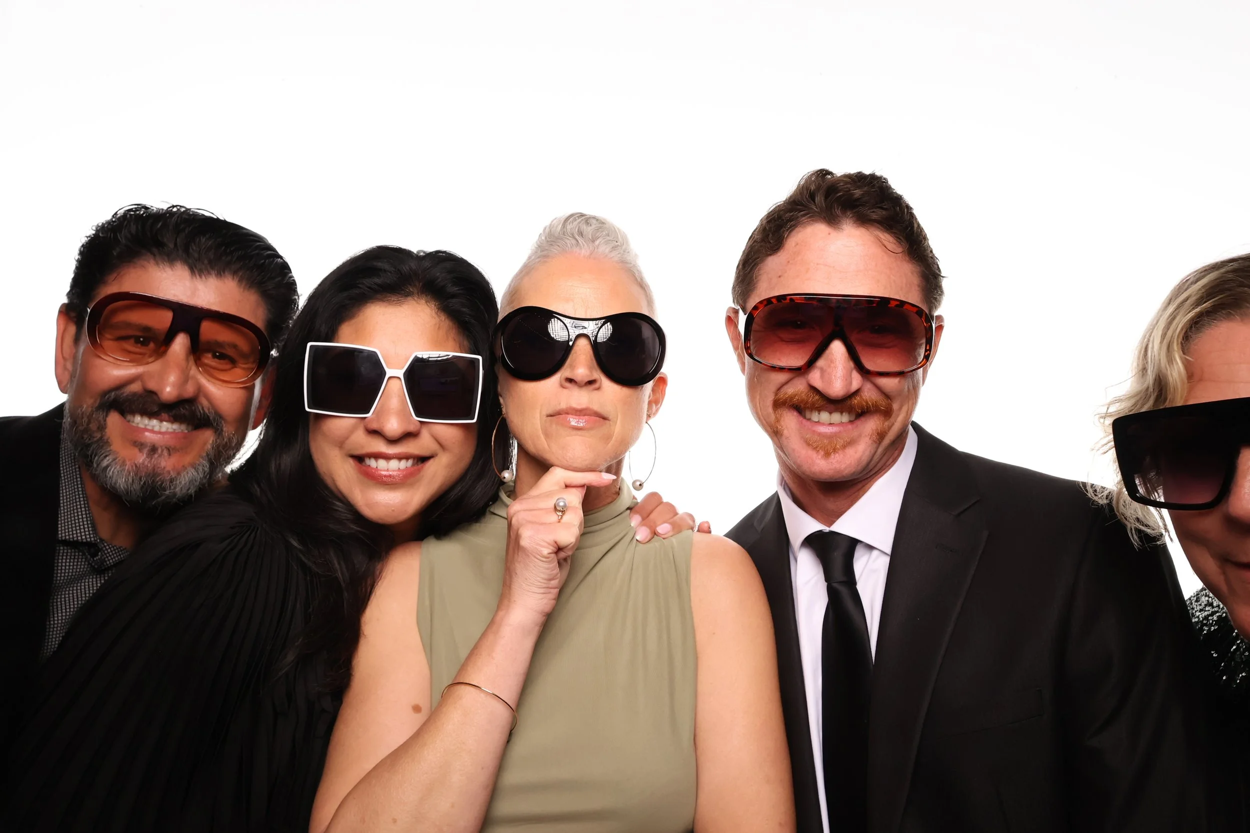 Klixbot booth pictures of a group of people wearing sunglasses and smiling, standing close together.