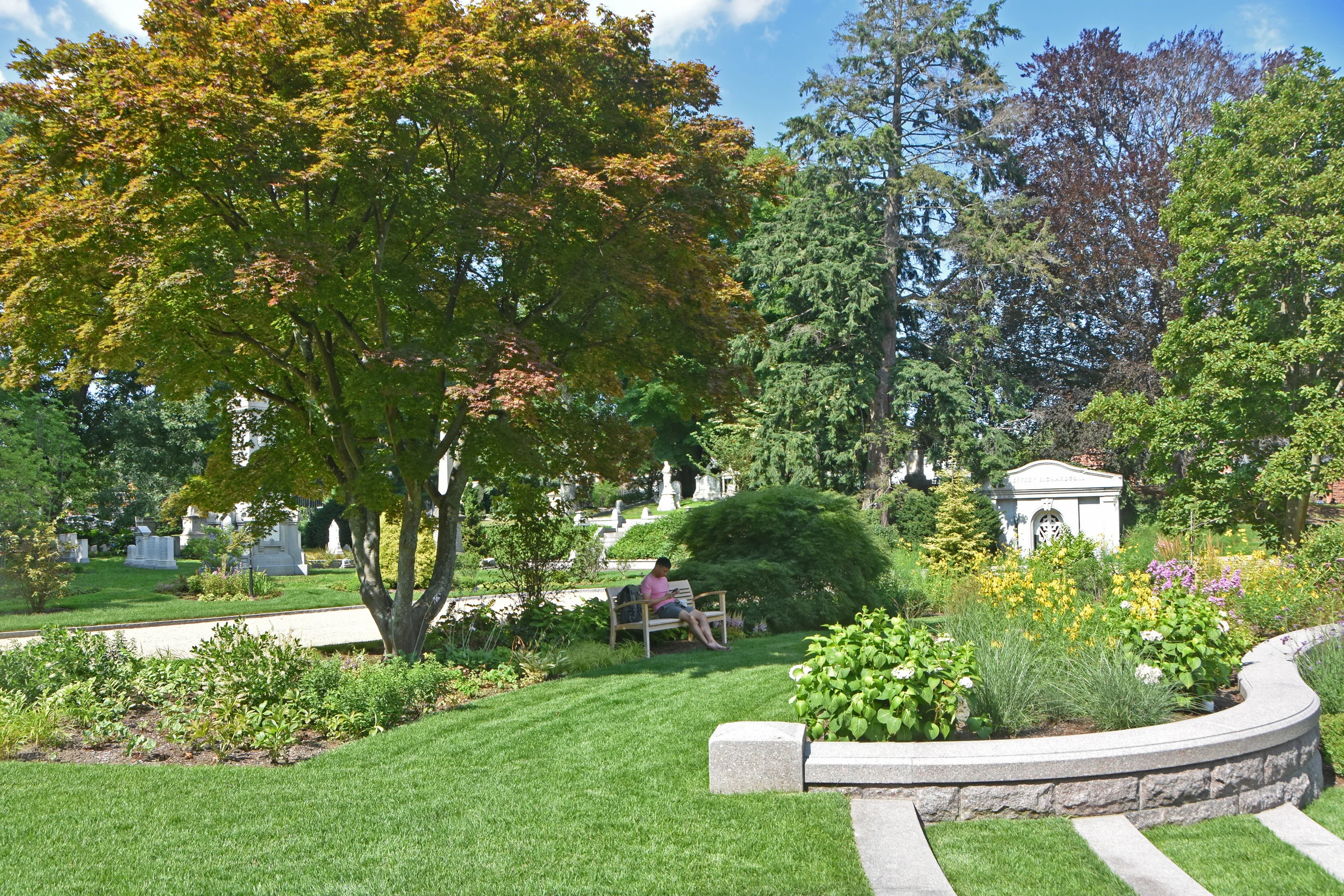 Shaded benches provide areas for people to sit and reflect. (photo by Jo Oltman)