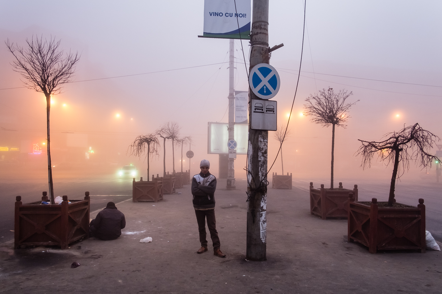 Wintry sunrise at Gara de Nord. The text "vino cu noi" ("come with us") stands over the head of Azavoae (19, grown up in orphanage until 18). Under the street, the tunnel that used to be "home" to many.