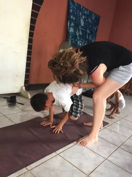 Alan taking on crow pose (and Estella getting ready for her turn right behind him...)