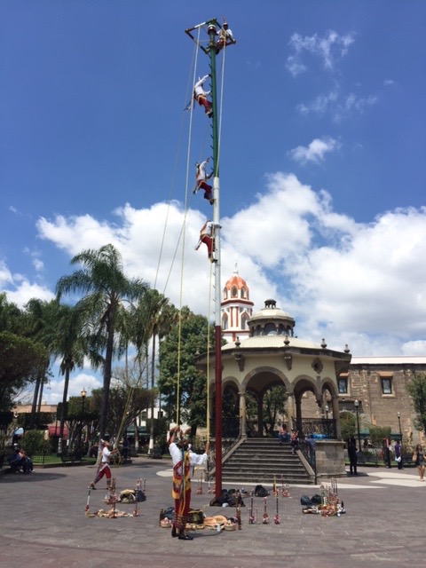 Voladores de Papantla - An ancien Mesoamerican ceremoy/ritual still performed today. The ritual consists of dance and the climbing of a 39 meter pole from which the participants then launch themselves tied with ropes to descend to the ground while one remains playing a flute and drum. 