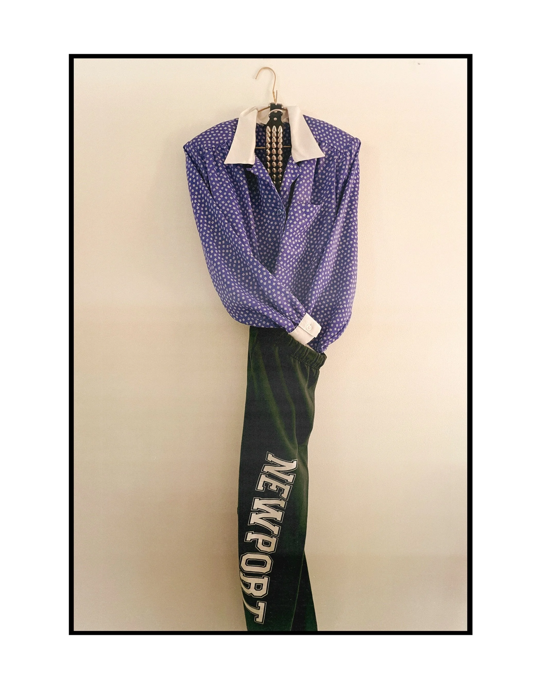 #OOTD. A slim green sweat pant with large graphic topped with a blue overly shouldered blouse and a stuffed neck cuff