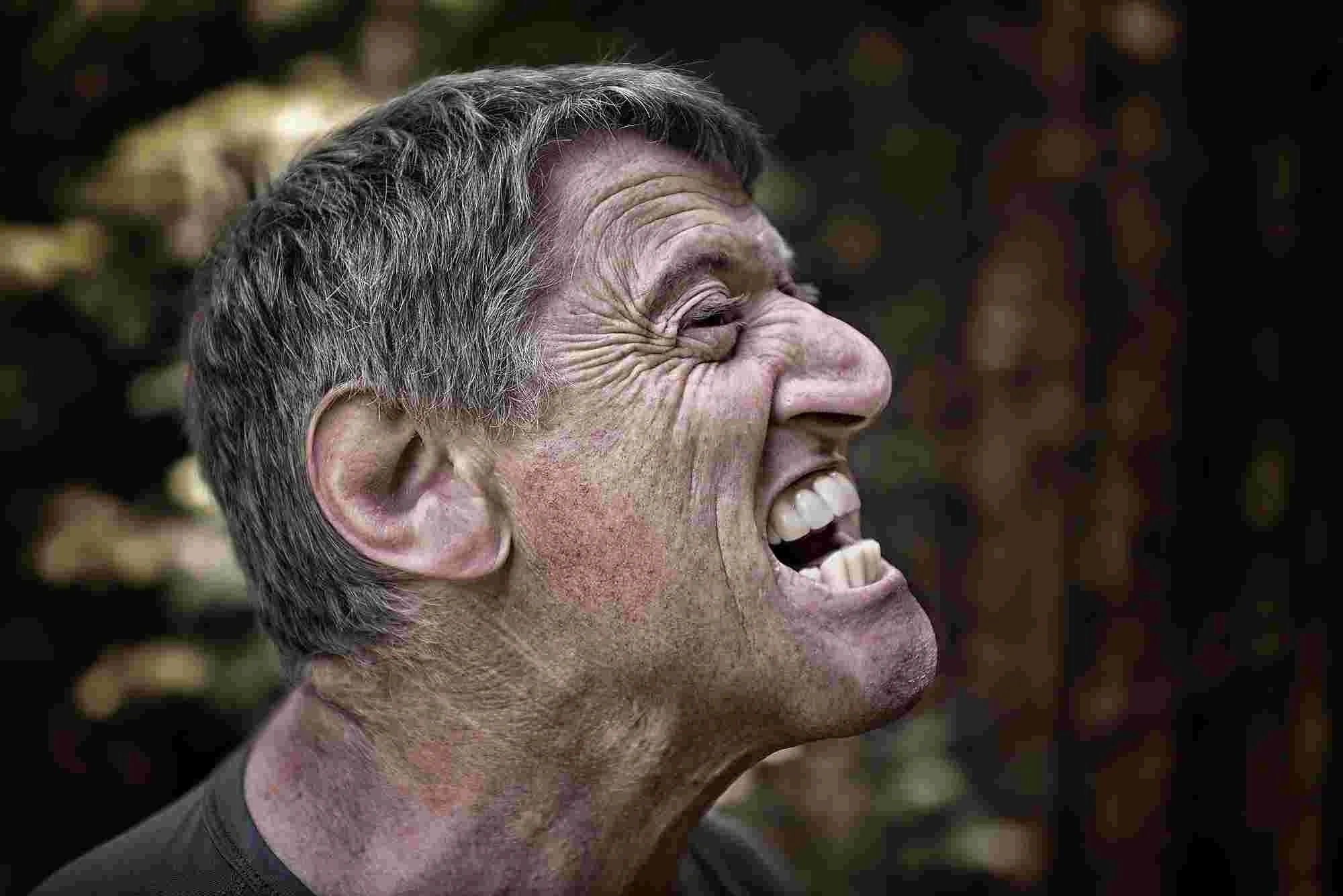 Man grimacing and yelling
