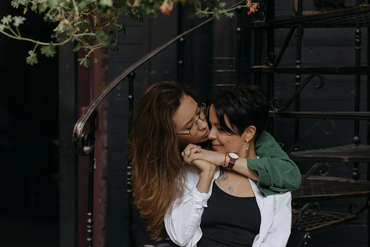 A Couple Holding Hands While Looking at Each Other