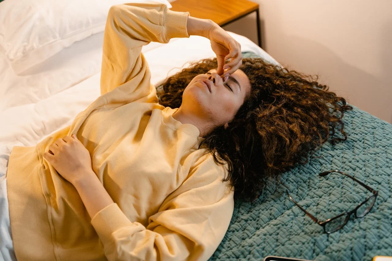 Woman on Sweatshirt Lying on Bed