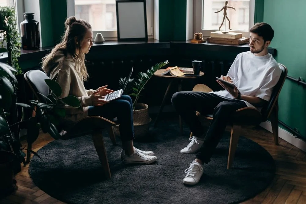 A couple sitting across from each other looking at each other