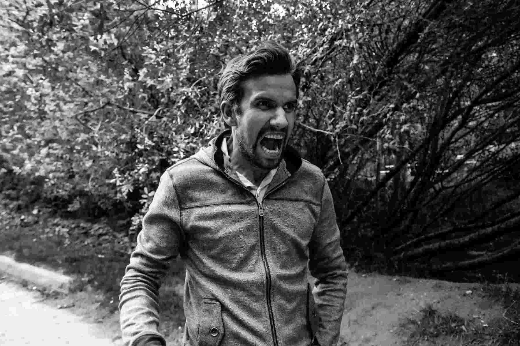 Man with angry look on face walking