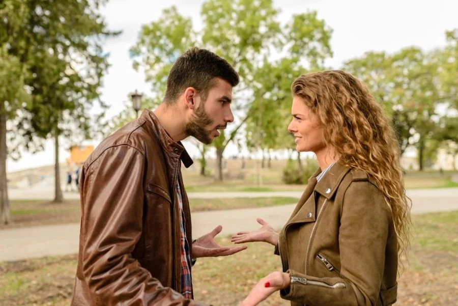 man and woman facing each other with frustrated looks on their faces
