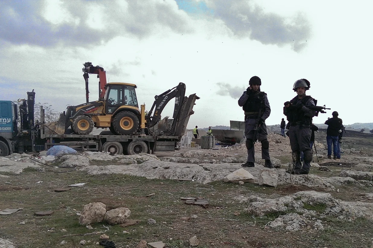 Israeli soldiers guard demolition of the camp