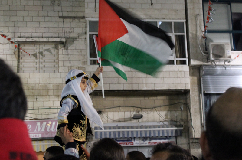Child waves Palestinian flags in Ramallah as president Abbas addresses the UN General Assembly asking for recognition as state on November 29, 2012. PHOTO: Lena Odgaard