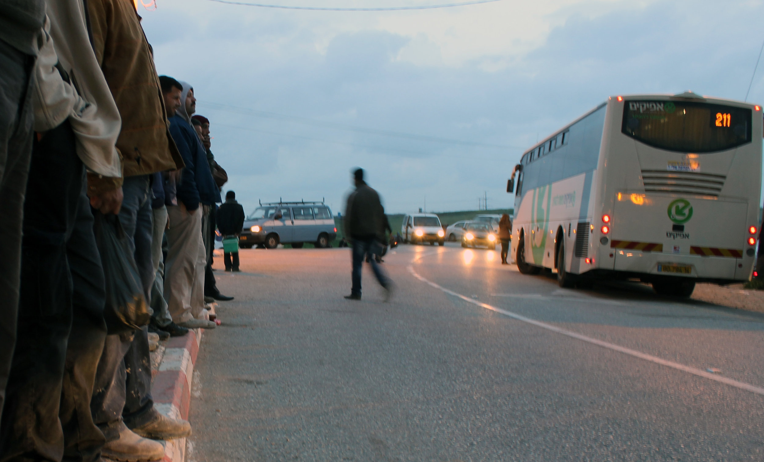20130305 - Palestinian workers at curb waiting for bus.jpg