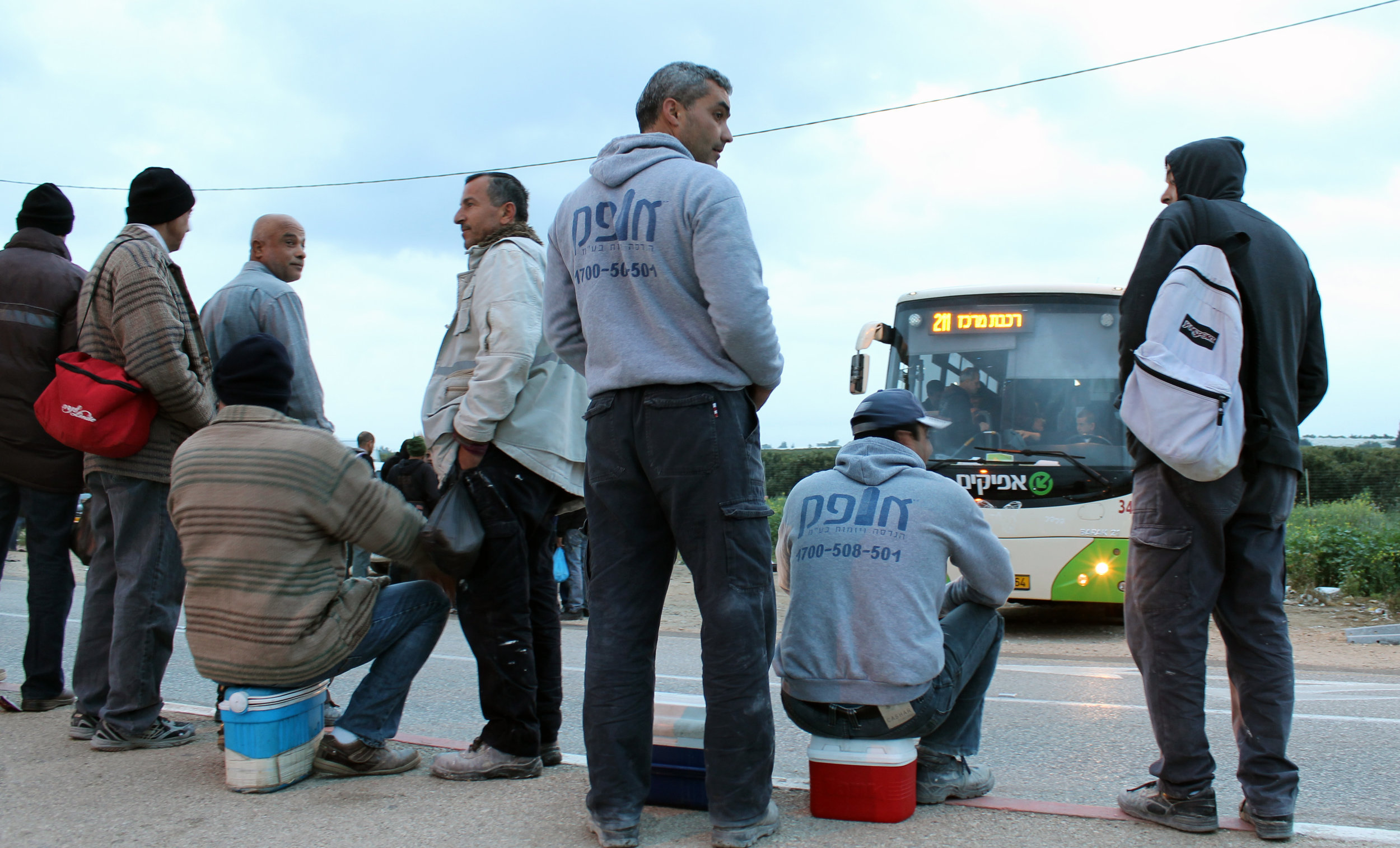 20130305 - Palestinian workers wait for bus.jpg