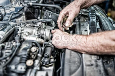 stock-photo-54196342-auto-mechanic-working-on-the-engine.jpg