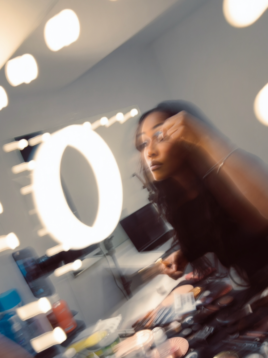 Makeup artist working behind the scenes for a photoshoot.