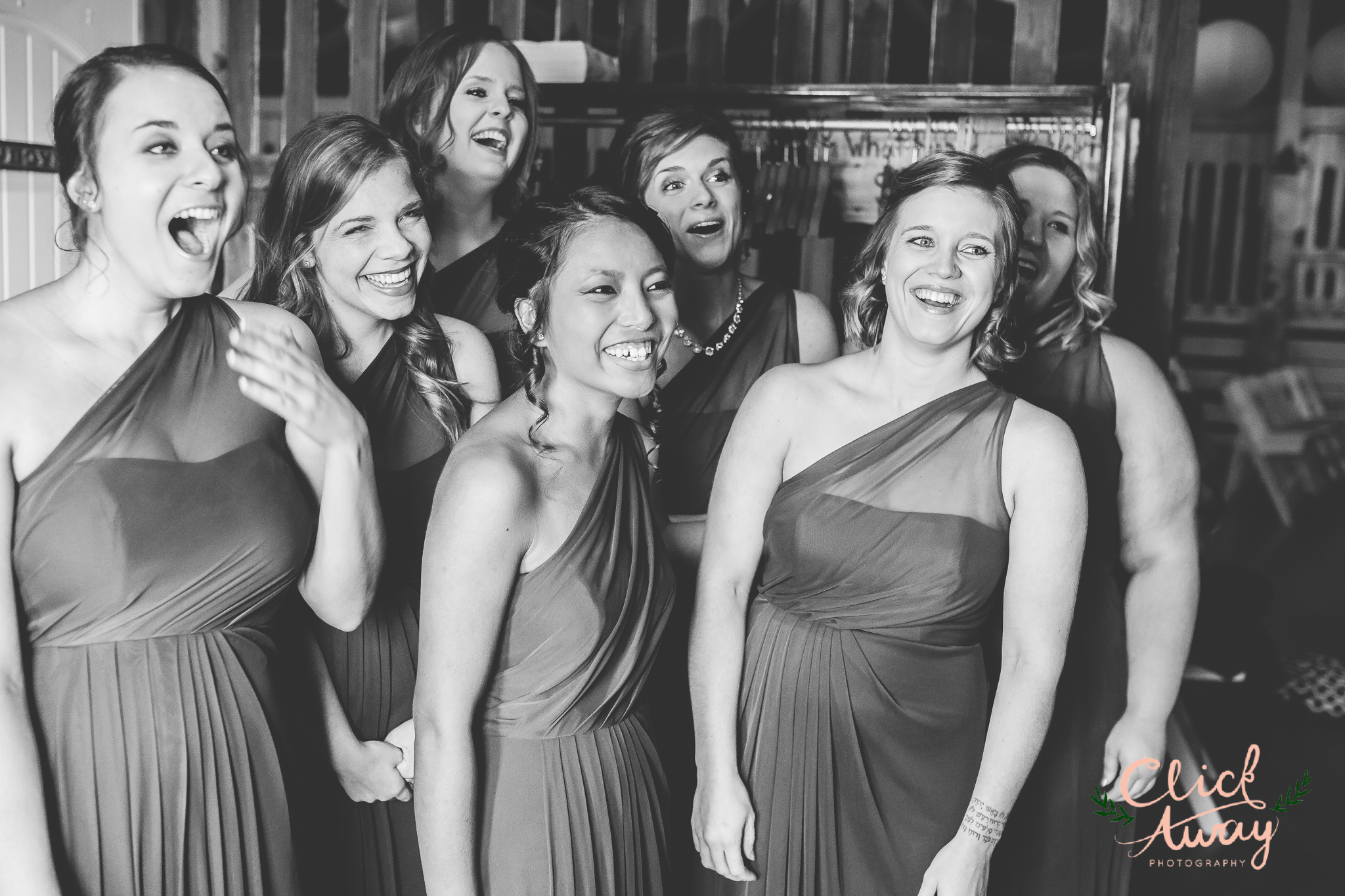 bridesmaids reacting to bride's dress in black and white
