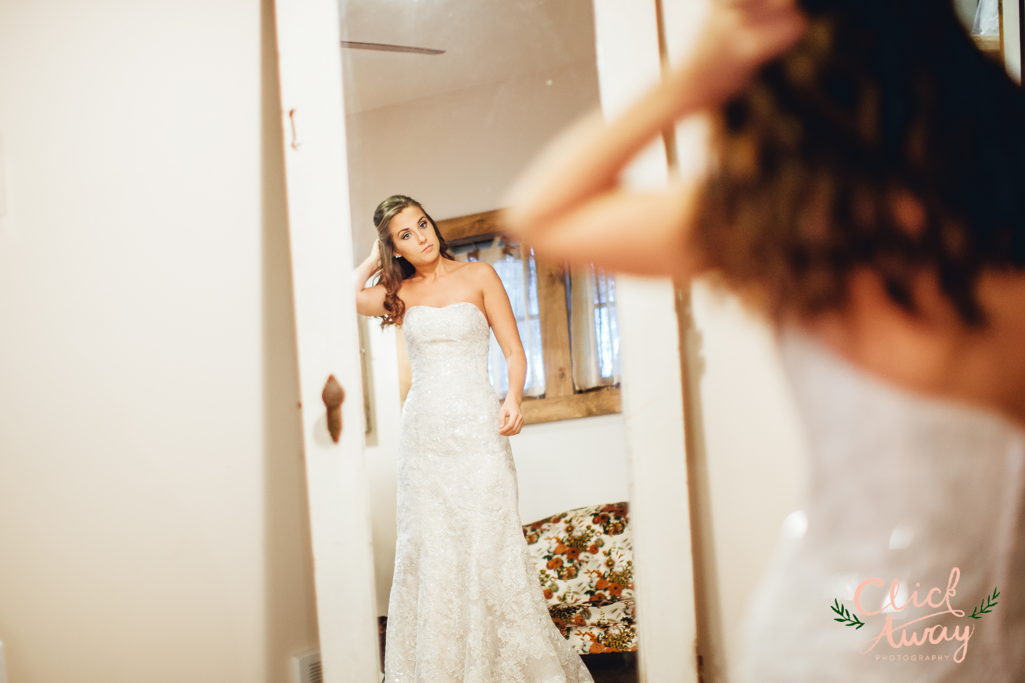 bride looking at herself on mirror pose