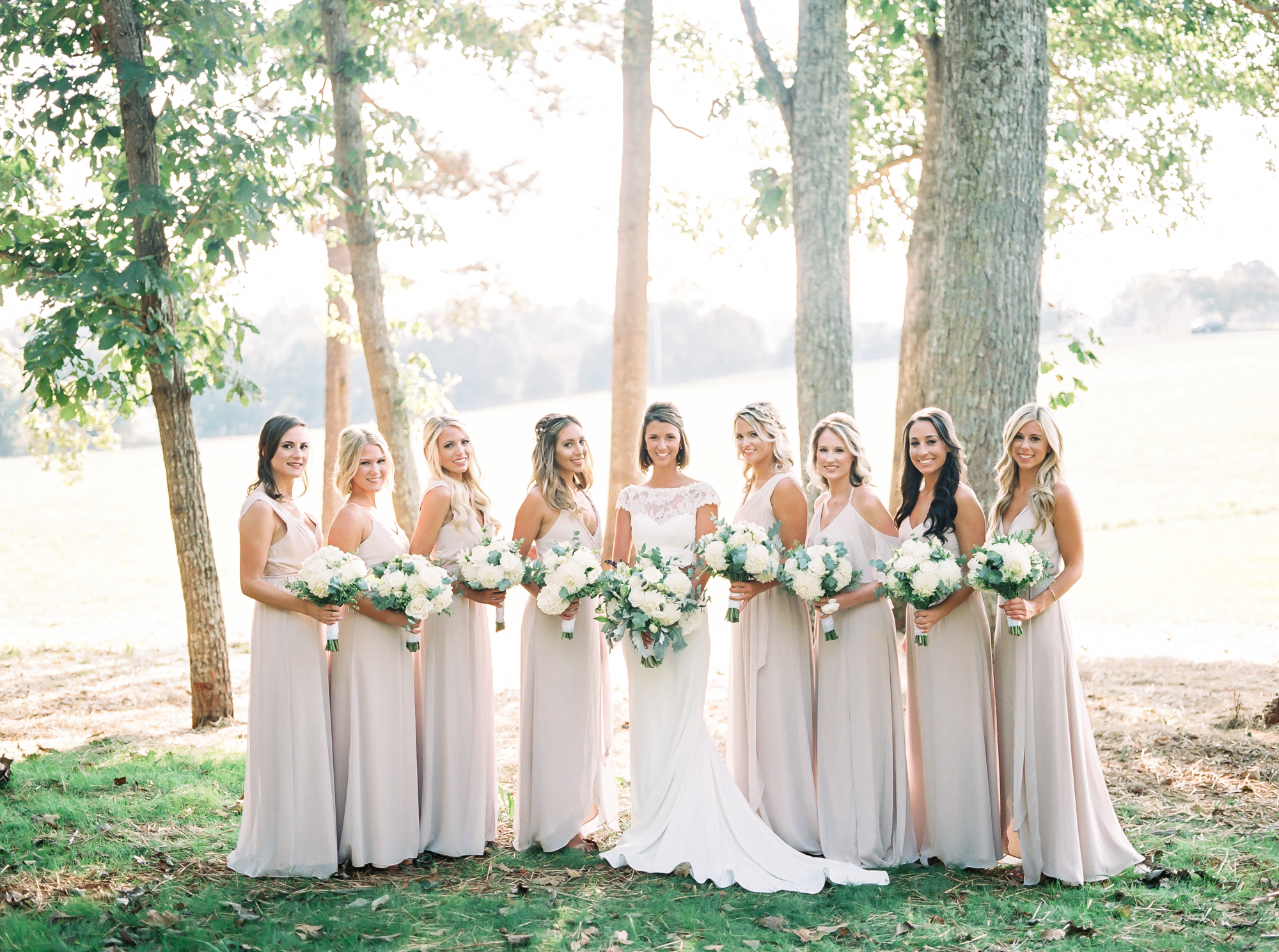 bride with bridesmaids in farmhouse wedding