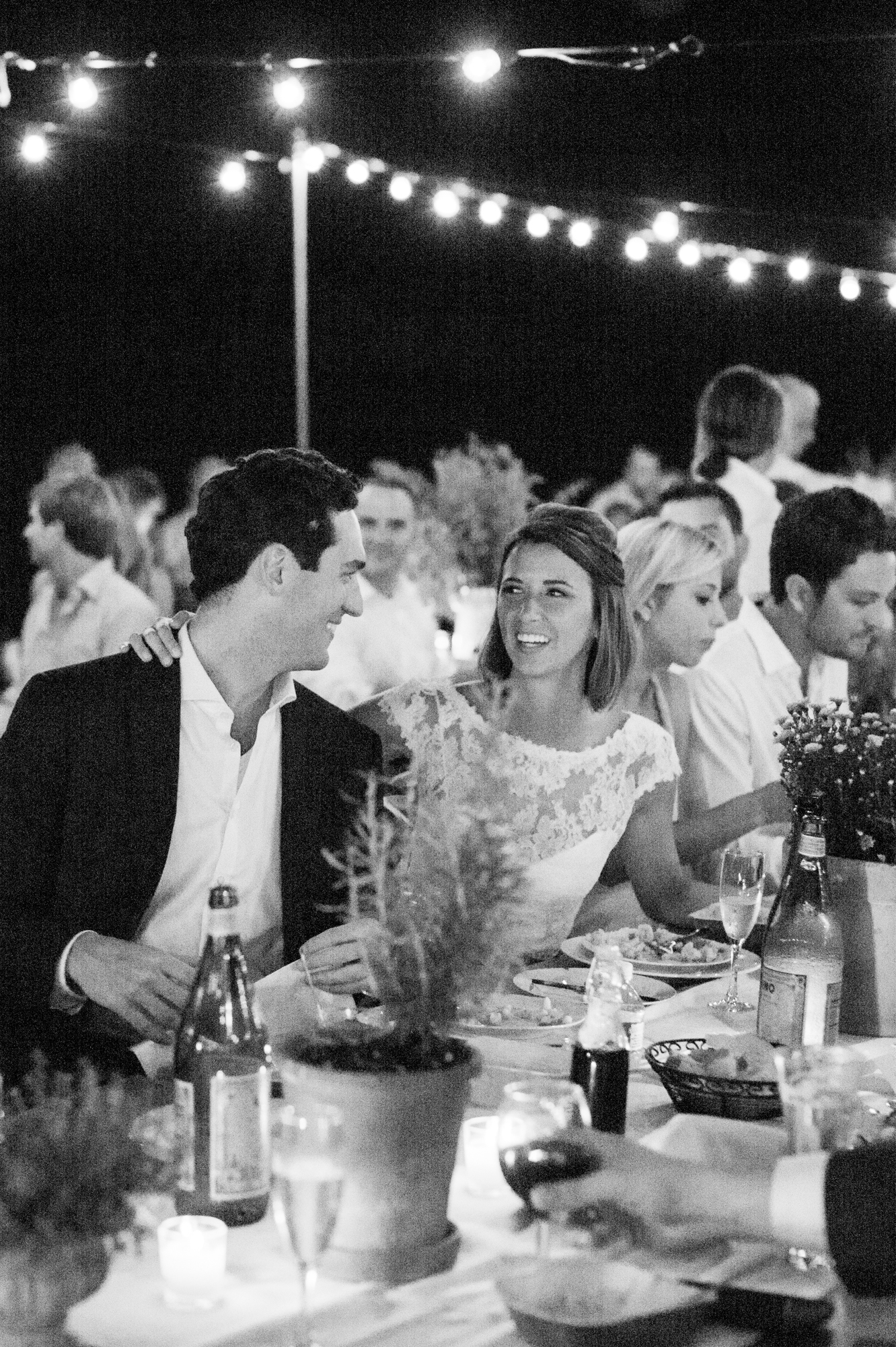bride and groom during toasts in black and white