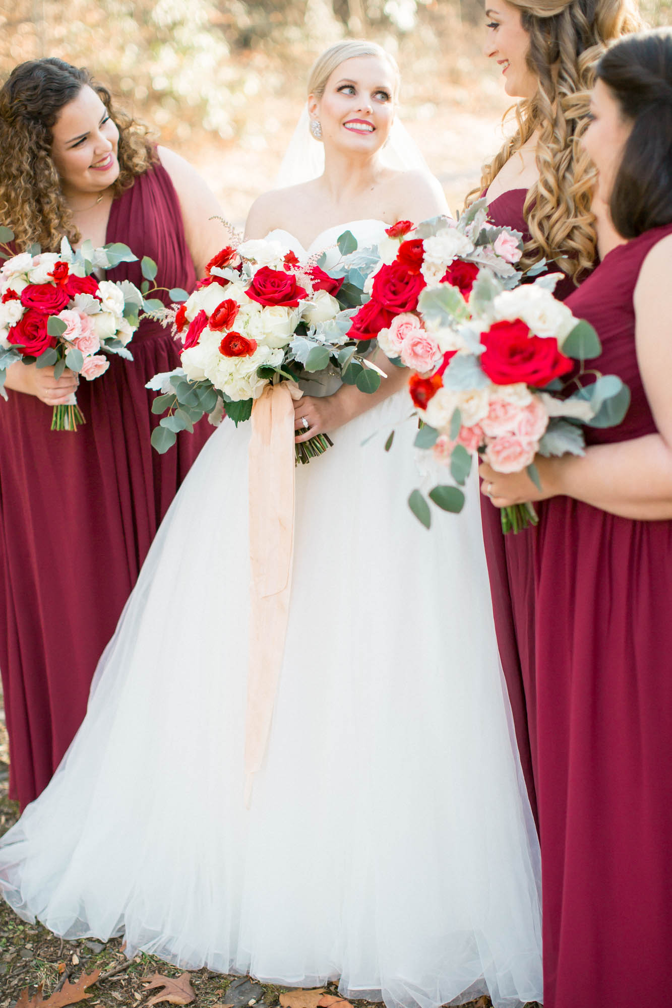 Bridesmaids and bride red and white bouquets
