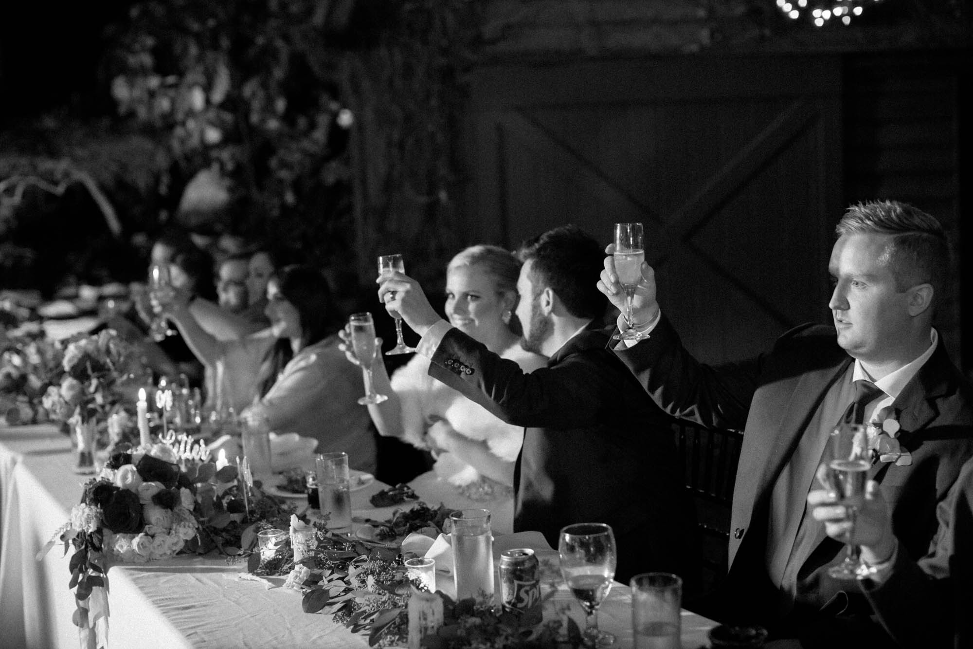 bride and groom toast in black and white