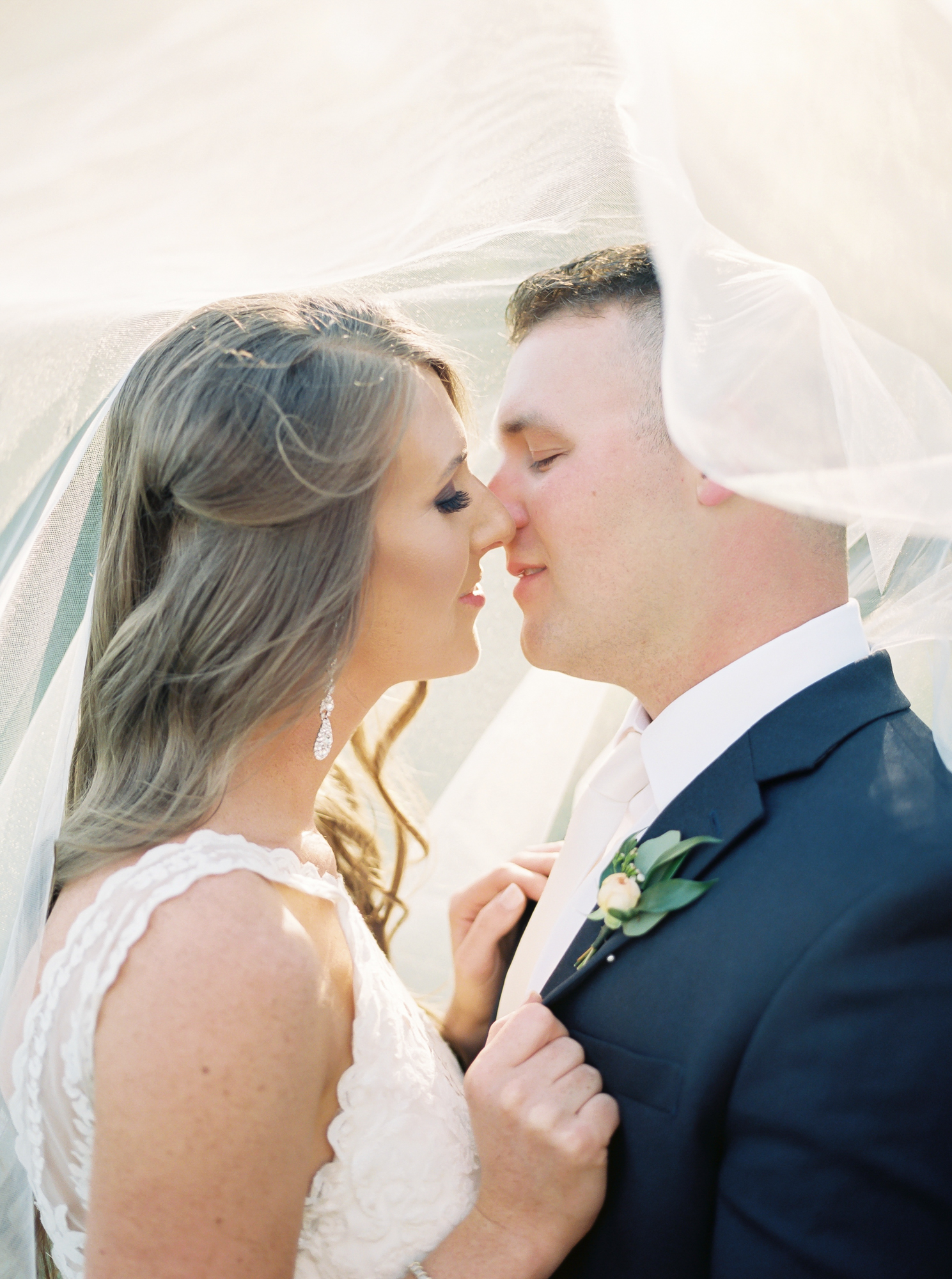 veil shot bride and groom on film