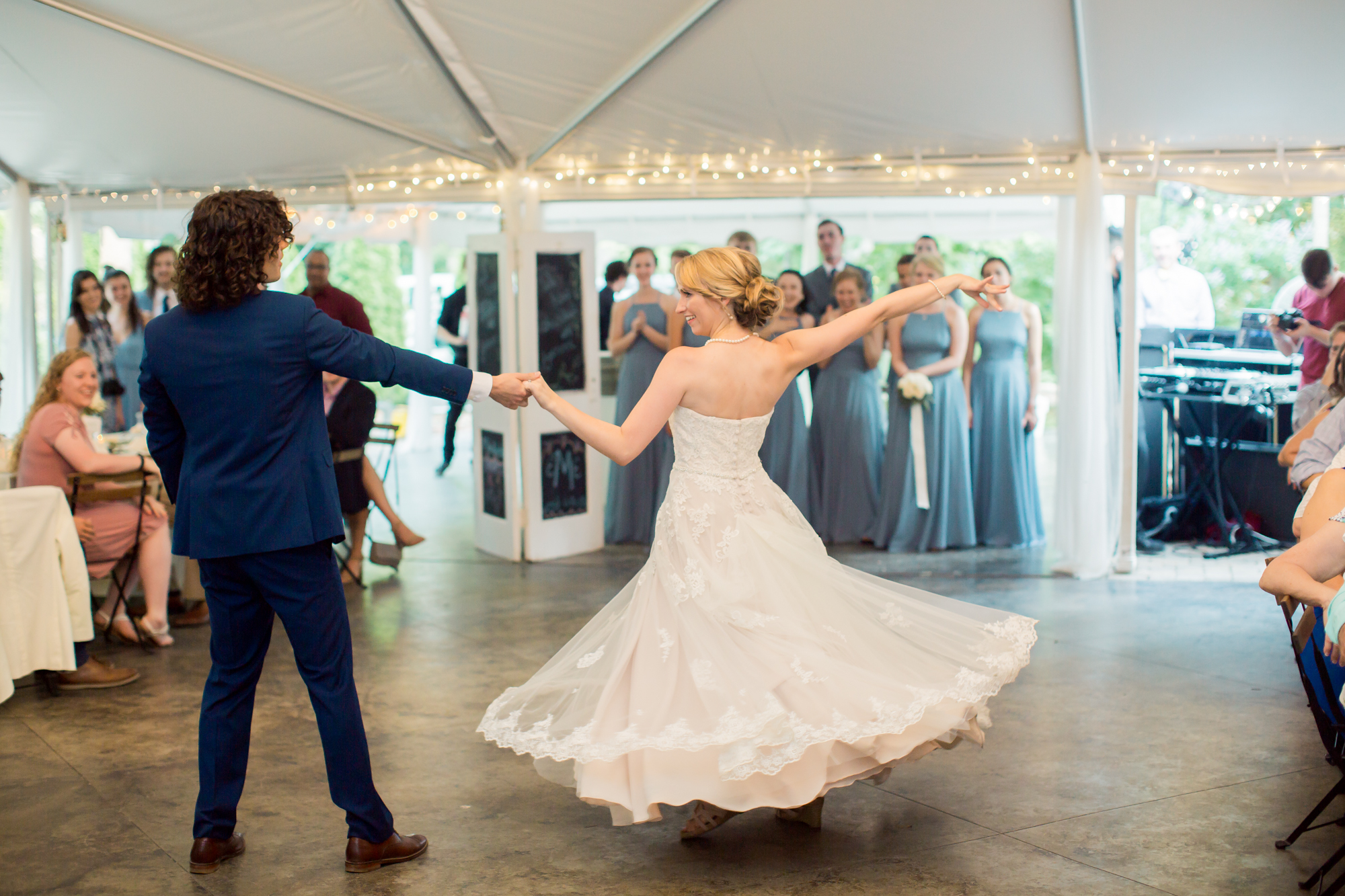 bride twirls in lace wedding dress