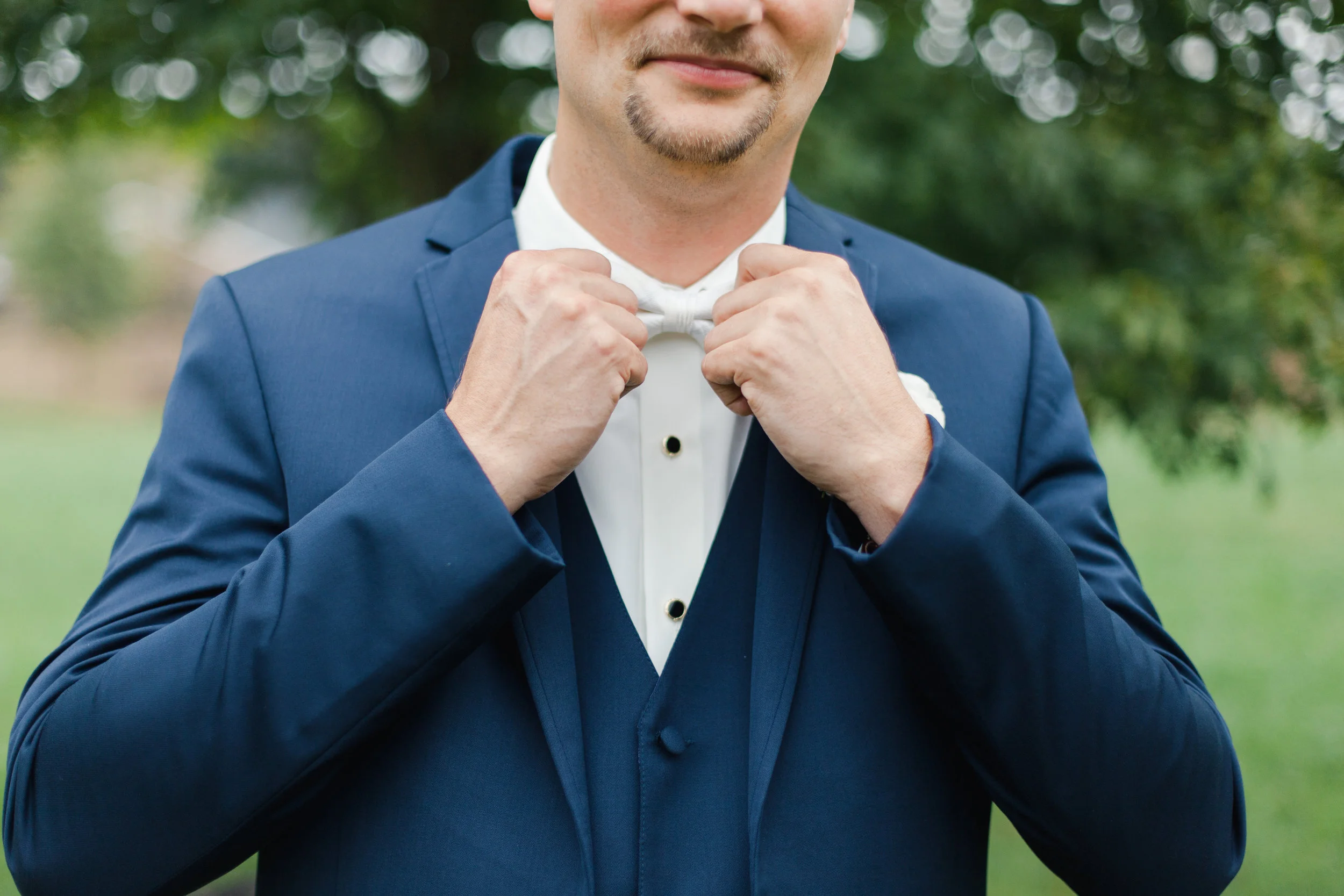 groom getting ready at johnson carriage house