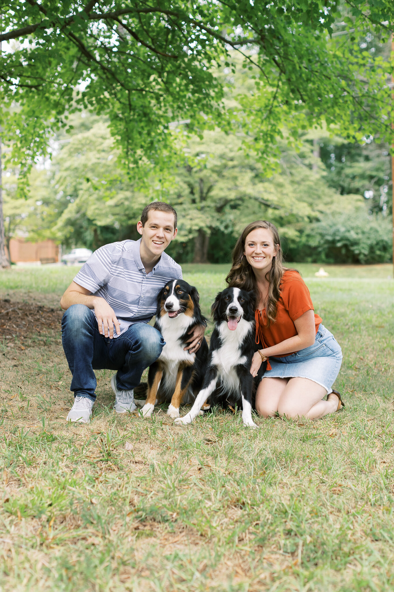 couple with Australian shepards